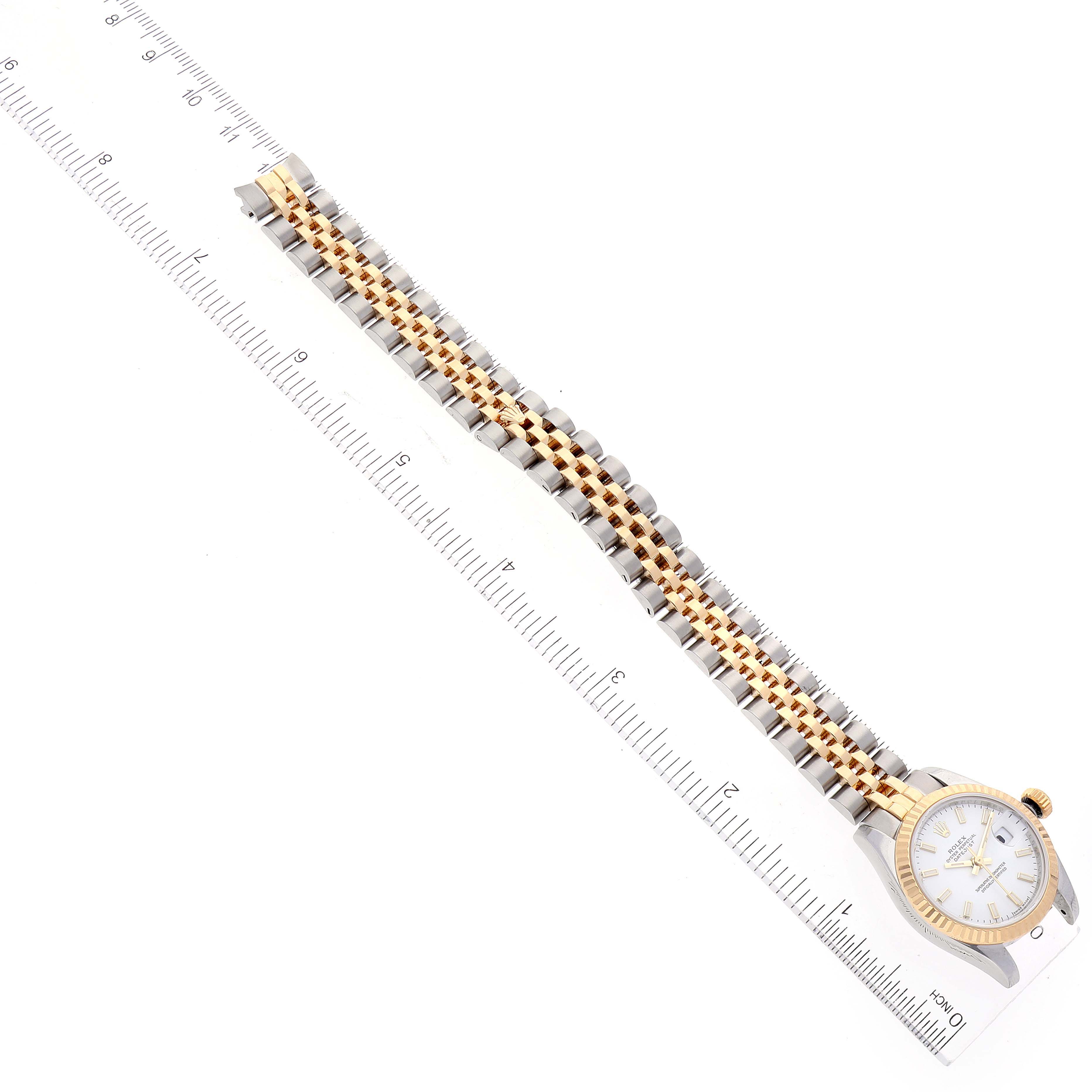 The Rolex Datejust 179173 Women
s Steel and Gold (two tone) White Dial 179173 Women
s Steel and Gold (two tone) White Dial watch is shown from a top-down angle, highlighting the full length of the band and the face.