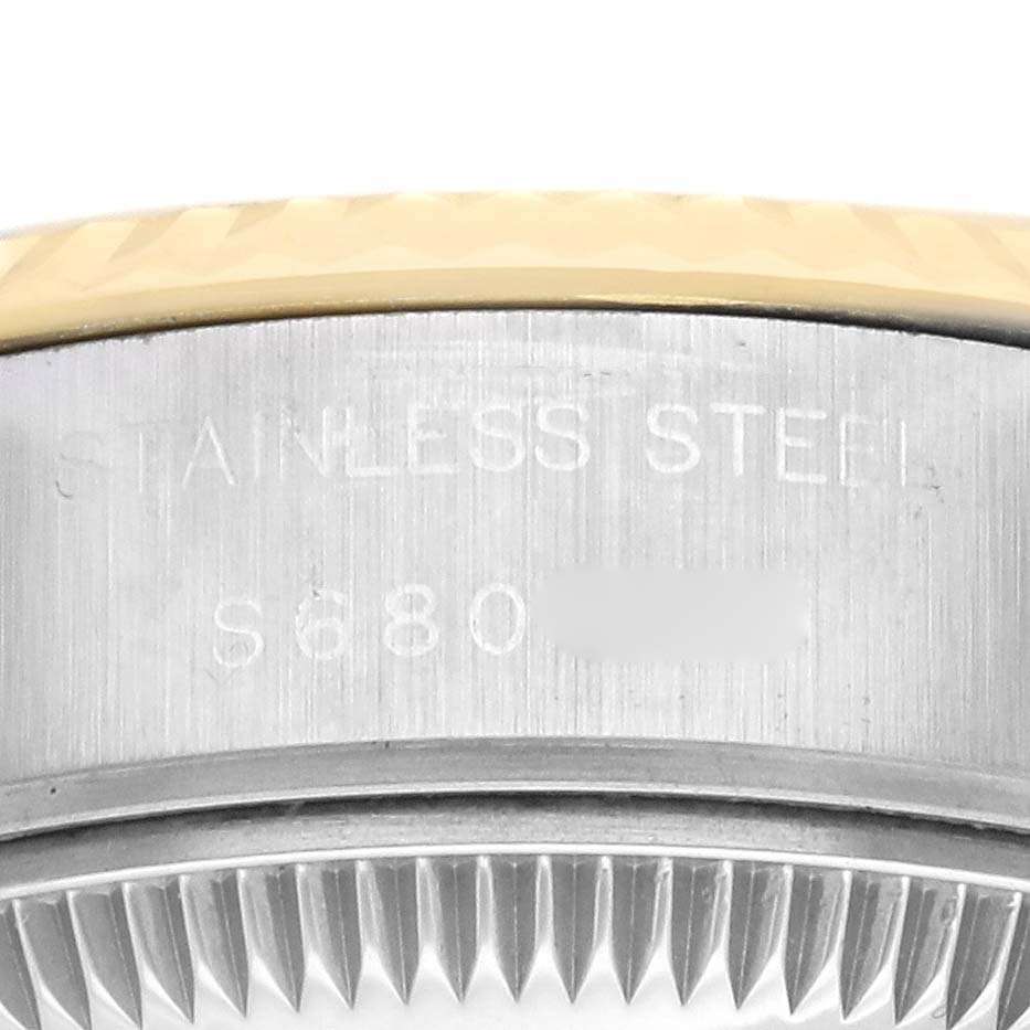 The image shows a close-up of the side of a Rolex Datejust 69173 Women's Steel and Gold (two tone) White Dial 69173 Women's Steel and Gold (two tone) White Dial watch, highlighting the bezel and part of the case with engraved details.