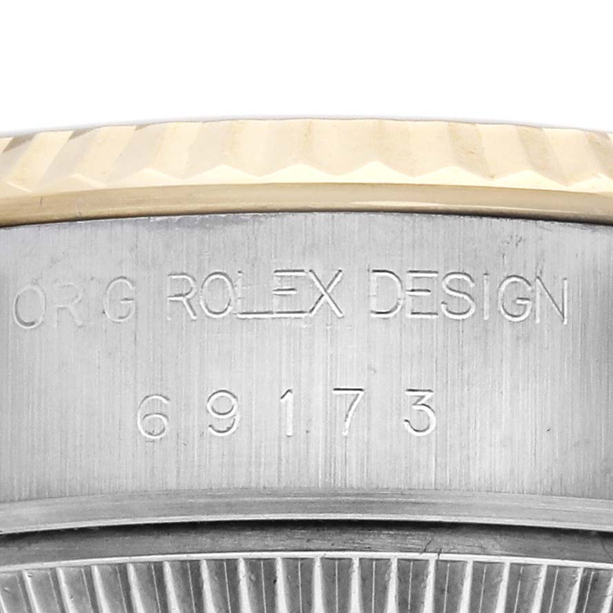 The image shows a close-up of the side of a Rolex Datejust 69173 Women's Steel and Gold (two tone) White Dial 69173 Women's Steel and Gold (two tone) White Dial watch, highlighting the engraved model number and "ROLEX DESIGN."
