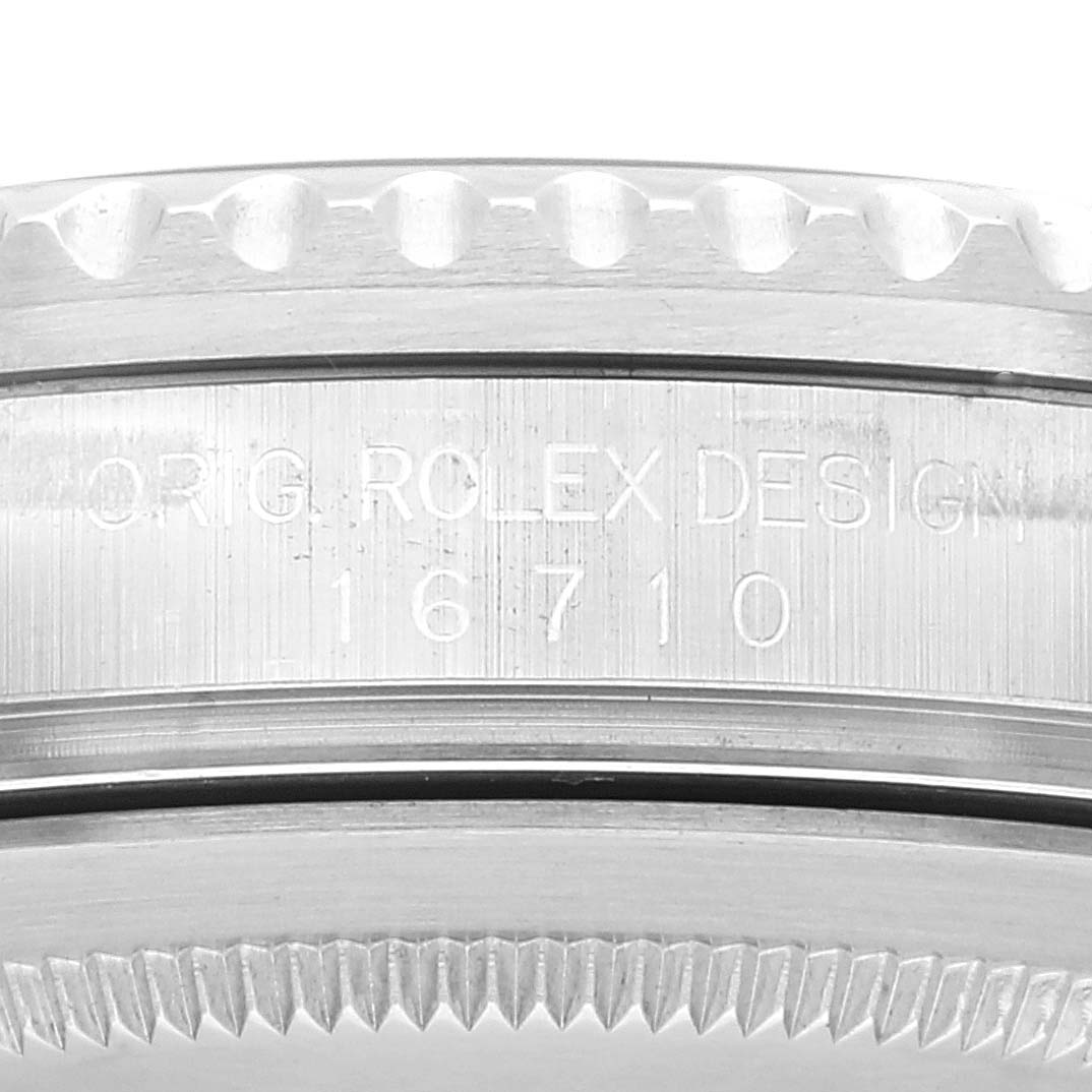 The image shows a close-up side view of the Rolex GMT-Master 16710 Men
s Stainless Steel Black Dial 16710 Men
s Stainless Steel Black Dial model, focusing on the engraved design and model number (16710).