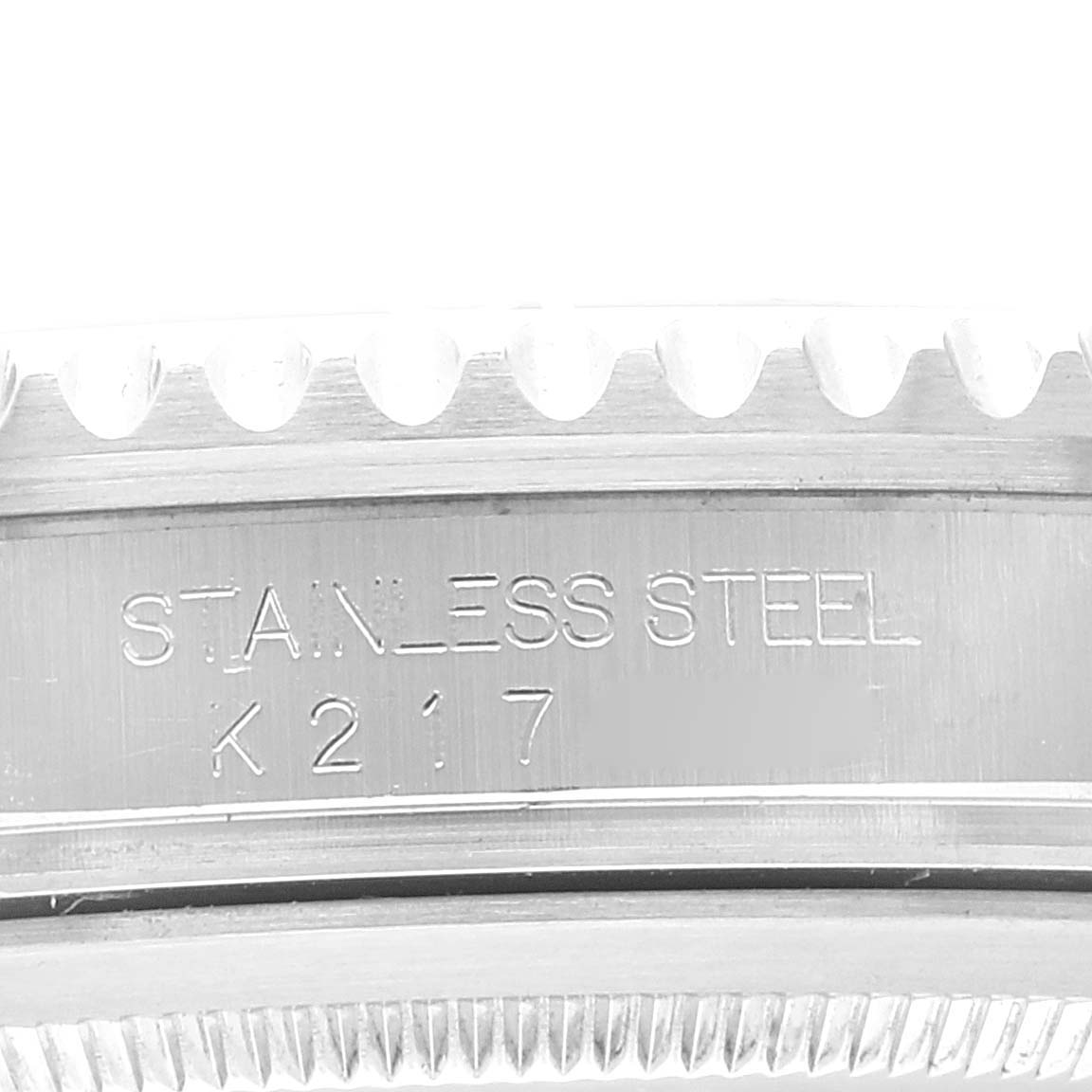 This image shows a close-up angle of the side of a Rolex GMT-Master 16710 Men's Stainless Steel Black Dial 16710 Men's Stainless Steel Black Dial watch case with "STAINLESS STEEL" engraved on it.