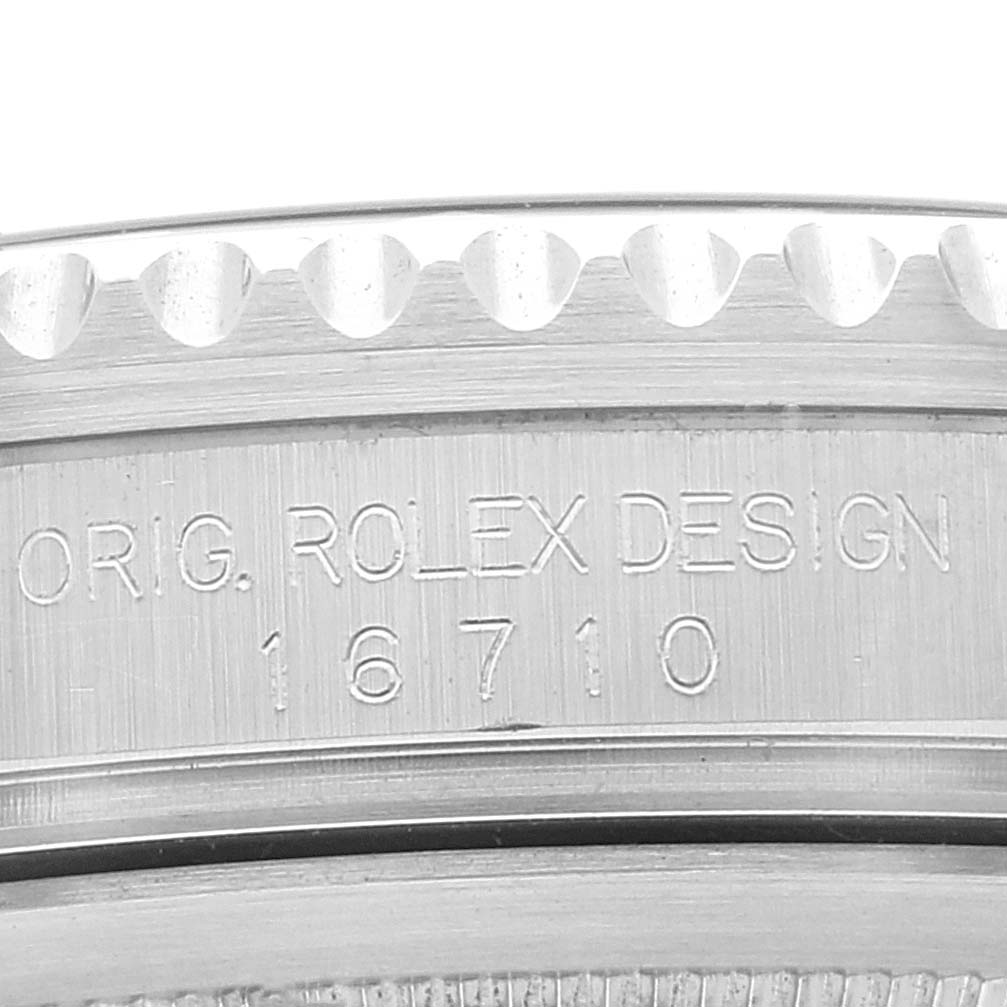 This image shows a close-up of the engraved side of a Rolex GMT-Master 16710 Men's Stainless Steel Black Dial 16710 Men's Stainless Steel Black Dial watch case, featuring the model number 16710.