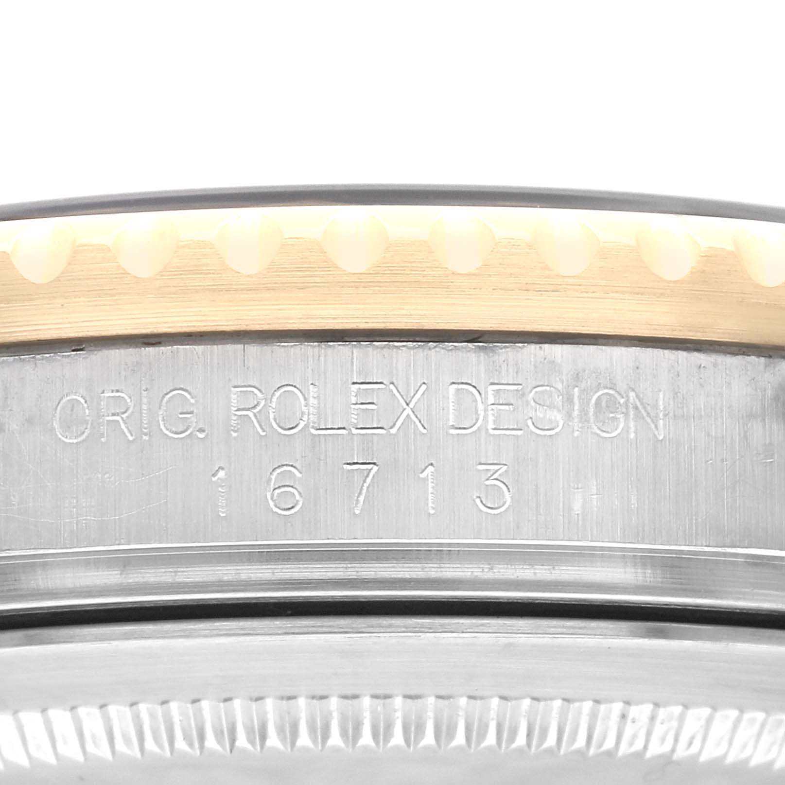 This image shows a close-up of the side engraving on the case of a Rolex GMT-Master 16713 Men's Steel and Gold (two tone) Black Dial 16713 Men's Steel and Gold (two tone) Black Dial model, displaying the model number 16713.