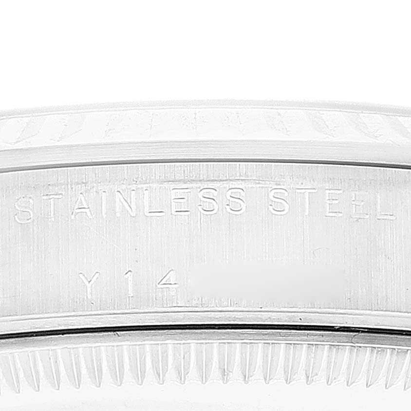 The image shows a close-up of the case back of a Rolex Mid-Size 77014 Women
s Stainless Steel Pink Dial 77014 Women
s Stainless Steel Pink Dial watch, highlighting the "STAINLESS STEEL" engraving.