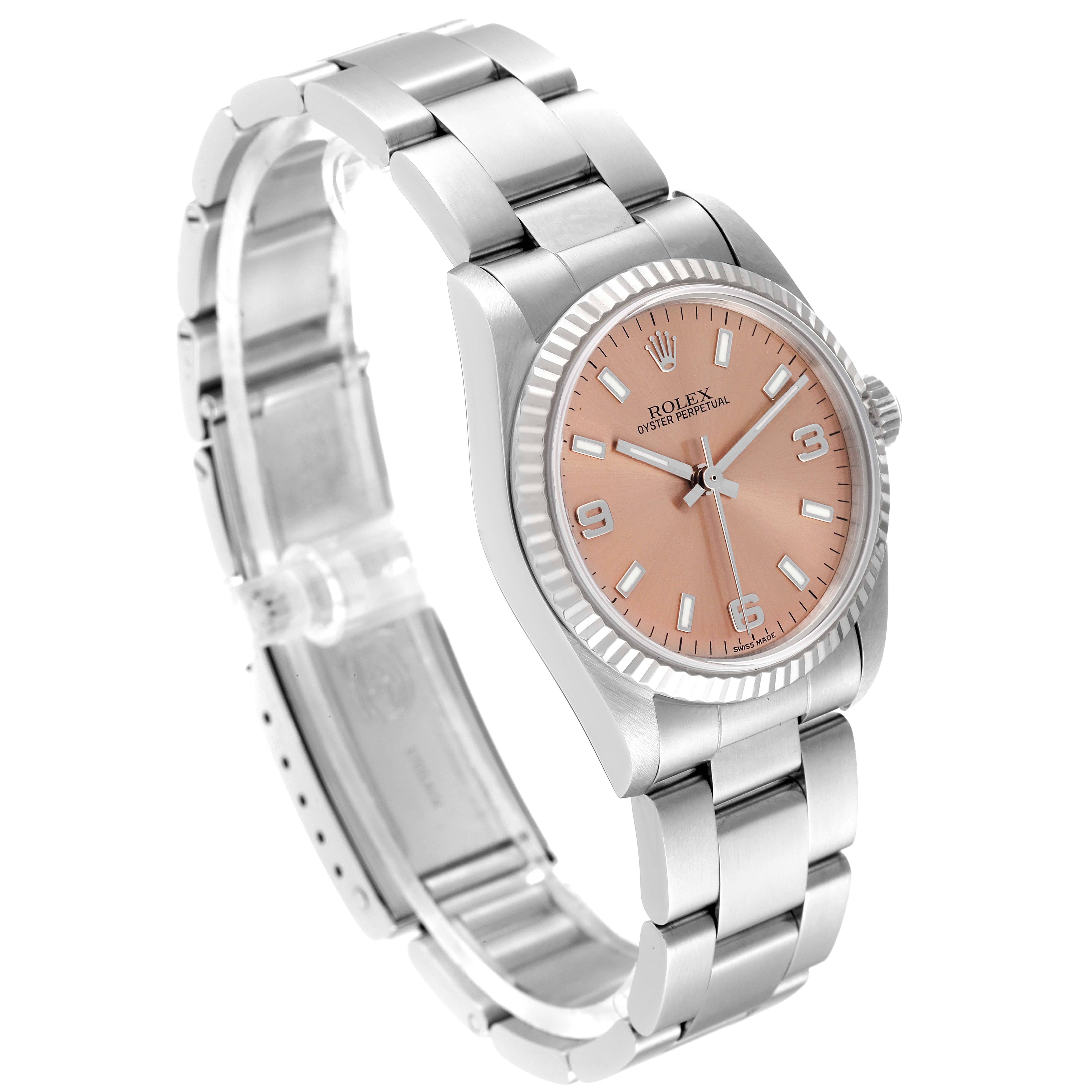 This image shows a Rolex Mid-Size 77014 Women
s Stainless Steel Pink Dial 77014 Women
s Stainless Steel Pink Dial Oyster Perpetual watch from an oblique angle, displaying the face, bezel, and bracelet.