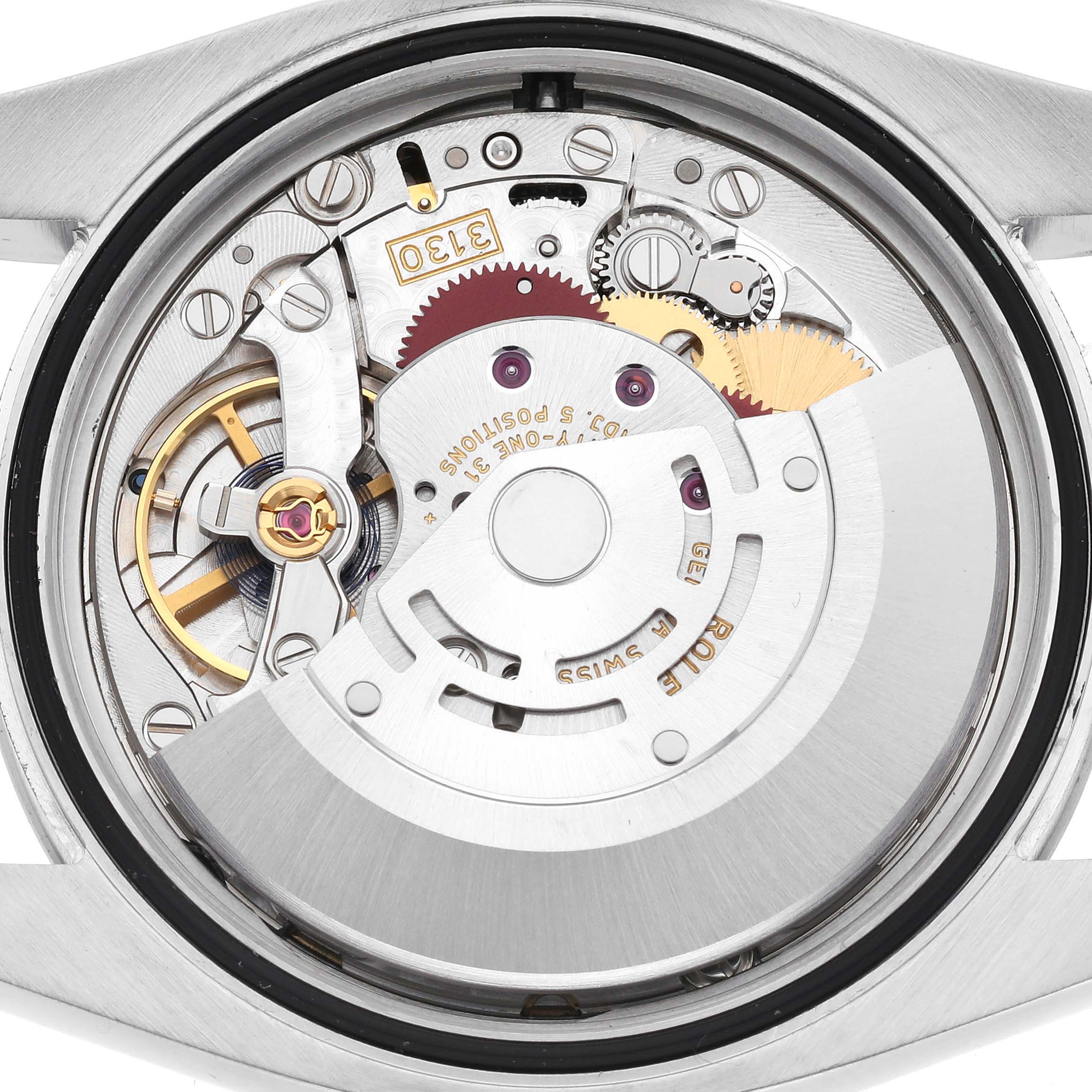 The image shows the movement and inner mechanical parts of a Rolex Oyster Perpetual 116000 Men's Stainless Steel Black Dial 116000 Men's Stainless Steel Black Dial watch from a rear angle.