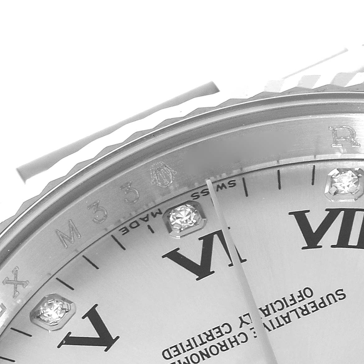 This image shows a close-up of the dial and part of the bezel of a Rolex Oyster Perpetual 116034 Men's Steel and Gold (two tone) Silver Dial 116034 Men's Steel and Gold (two tone) Silver Dial watch, featuring Roman numerals and diamond markers.