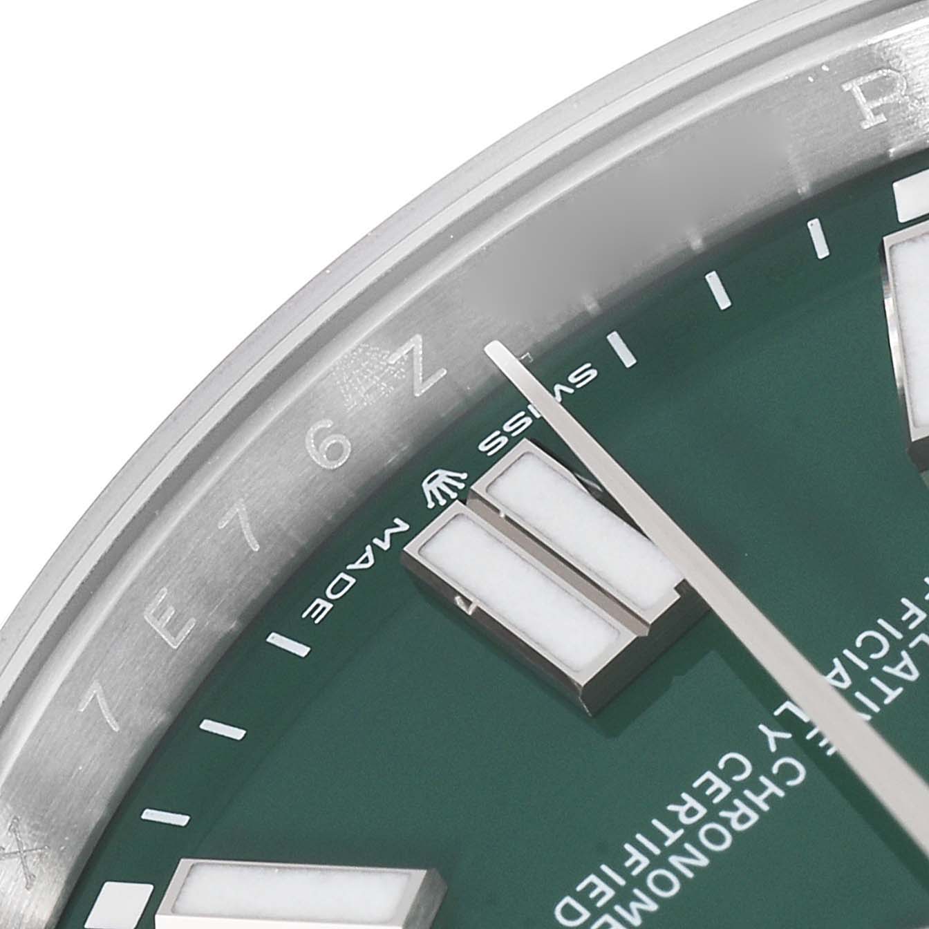 The image shows a close-up of the dial, bezel, and markers of a Rolex Oyster Perpetual 124300 Men's Stainless Steel Green Dial 124300 Men's Stainless Steel Green Dial watch.