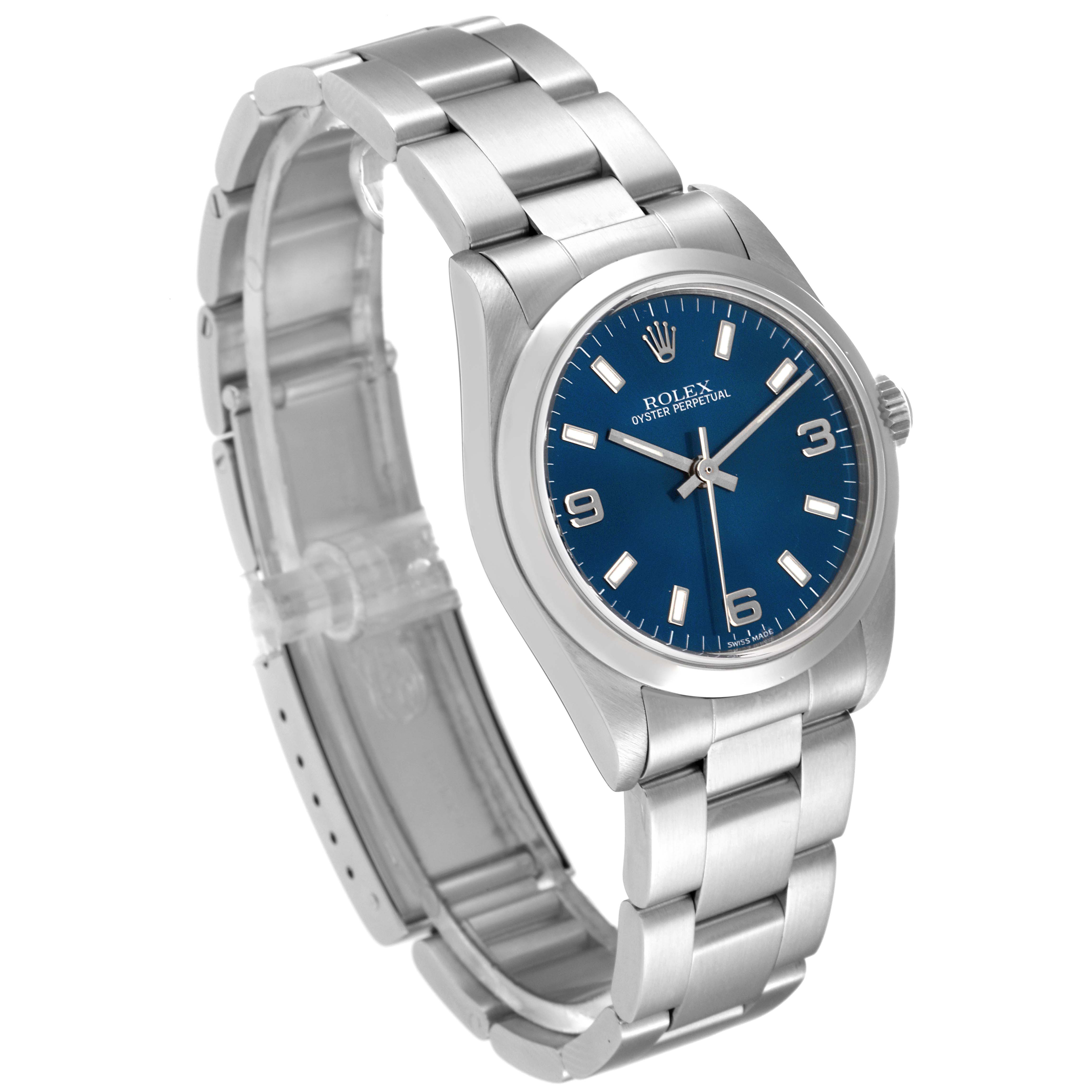 The image shows a Mid-Size Rolex watch with a blue dial and stainless steel bracelet, viewed at a three-quarter angle.