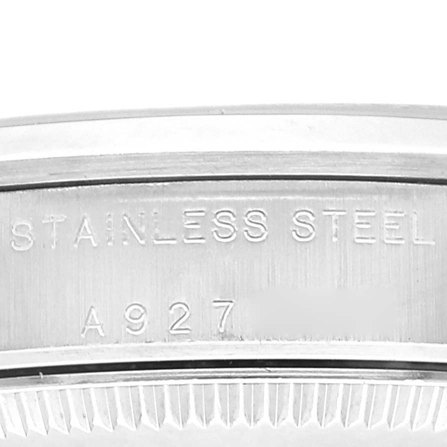 Close-up of the case side engraving on a stainless steel Rolex Mid-Size 77080 Women's Stainless Steel Blue Dial 77080 Women's Stainless Steel Blue Dial model, showing "STAINLESS STEEL" and part of the serial number.