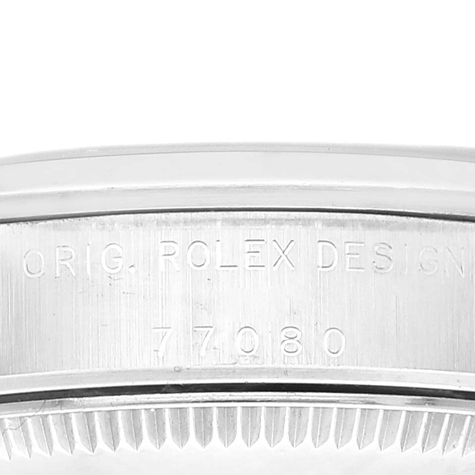 The image shows the engraved side of the mid-size Rolex watch case, displaying "ORIG. ROLEX DESIGN" and the model number "77080".