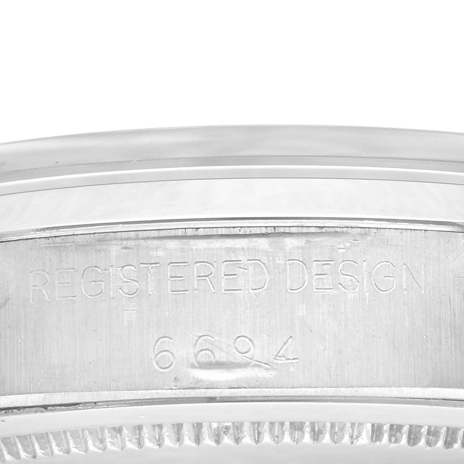 This close-up image shows the engraved side of the case of a Rolex Vintage Collection 6694 Men's Stainless Steel Silver Dial 6694 Men's Stainless Steel Silver Dial model watch, featuring the registered design number.
