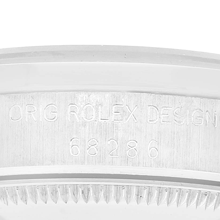 This image shows a close-up of the side of a Rolex President 68286 Women's Platinum Silver Dial 68286 Women's Platinum Silver Dial model watch, highlighting the serial number and "ORIG ROLEX DESIGN" engraving.