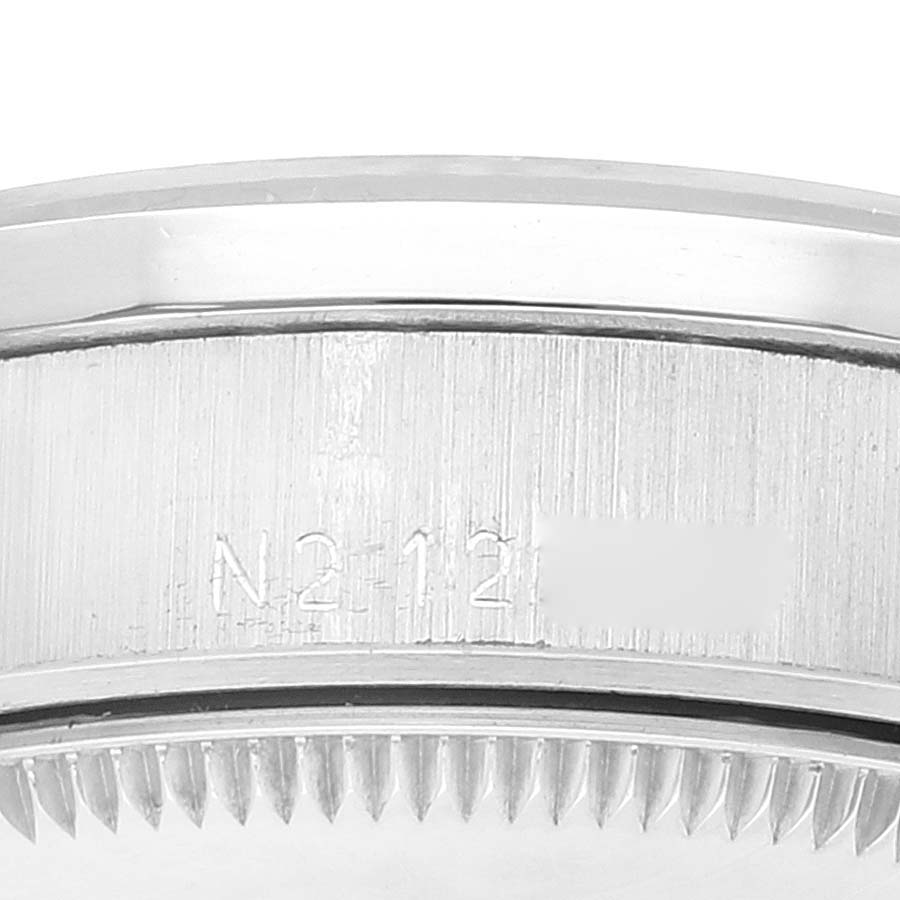 This image shows a close-up view of the side of the Rolex President 68286 Women's Platinum Silver Dial 68286 Women's Platinum Silver Dial model, featuring the bezel and part of the engraved serial number.