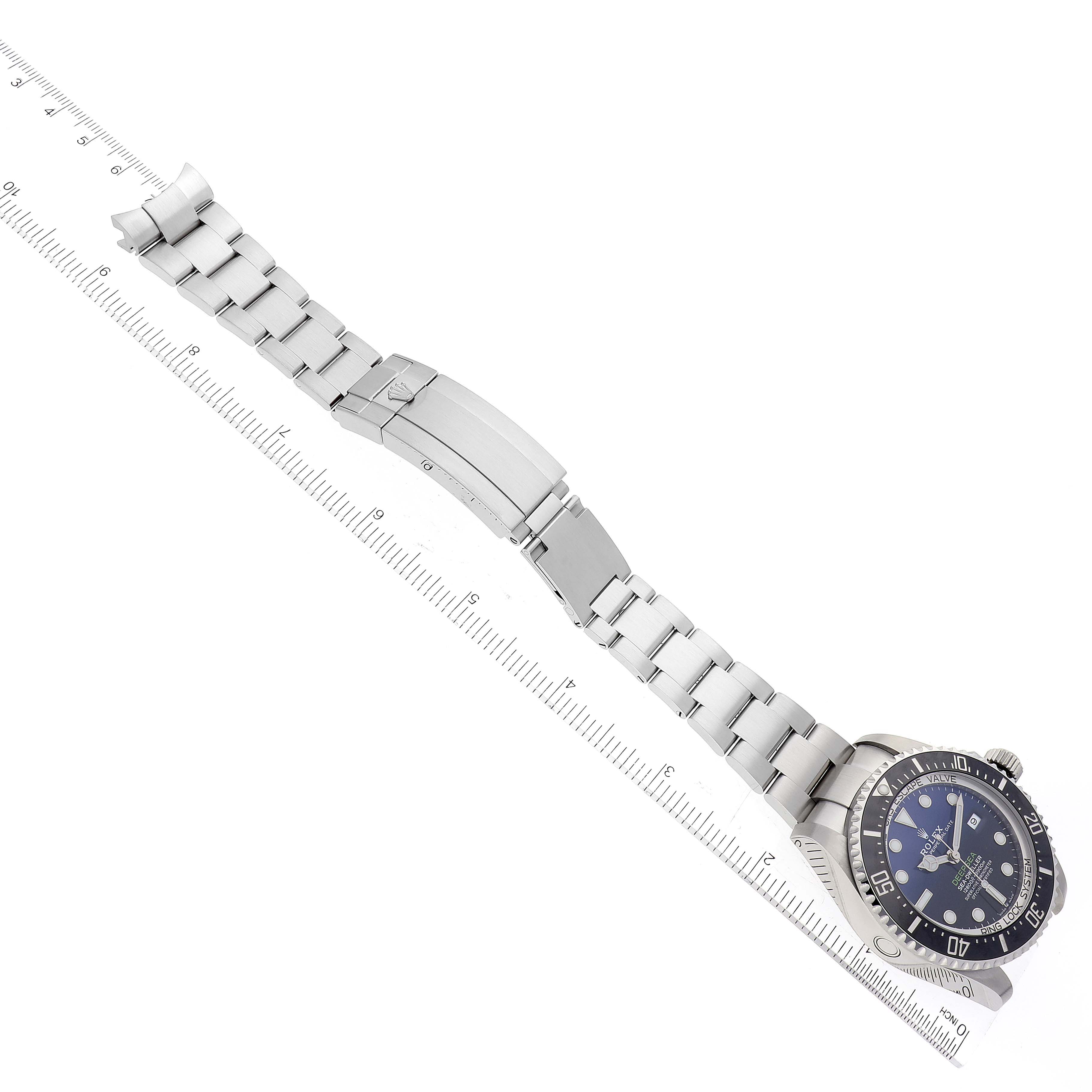 The image shows a Rolex Sea-Dweller 126660 Men's Stainless Steel Black Dial 126660 Men's Stainless Steel Black Dial watch laid flat, displaying its face, bezel, and bracelet with a ruler beside it.