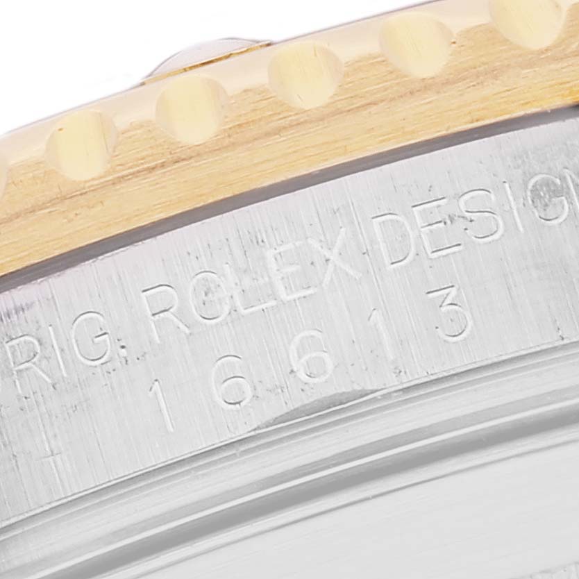 The image shows a close-up of the bezel and outer case edge, with model and brand markings, of a Rolex Submariner 16613 Men's Steel and Gold (two tone) Blue Dial 16613 Men's Steel and Gold (two tone) Blue Dial watch.