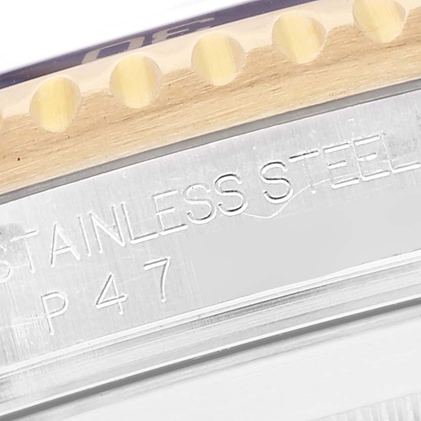 This close-up image shows the stainless steel edge and part of the bezel of a Rolex Submariner 16613 Men's Steel and Gold (two tone) Blue Dial 16613 Men's Steel and Gold (two tone) Blue Dial watch.