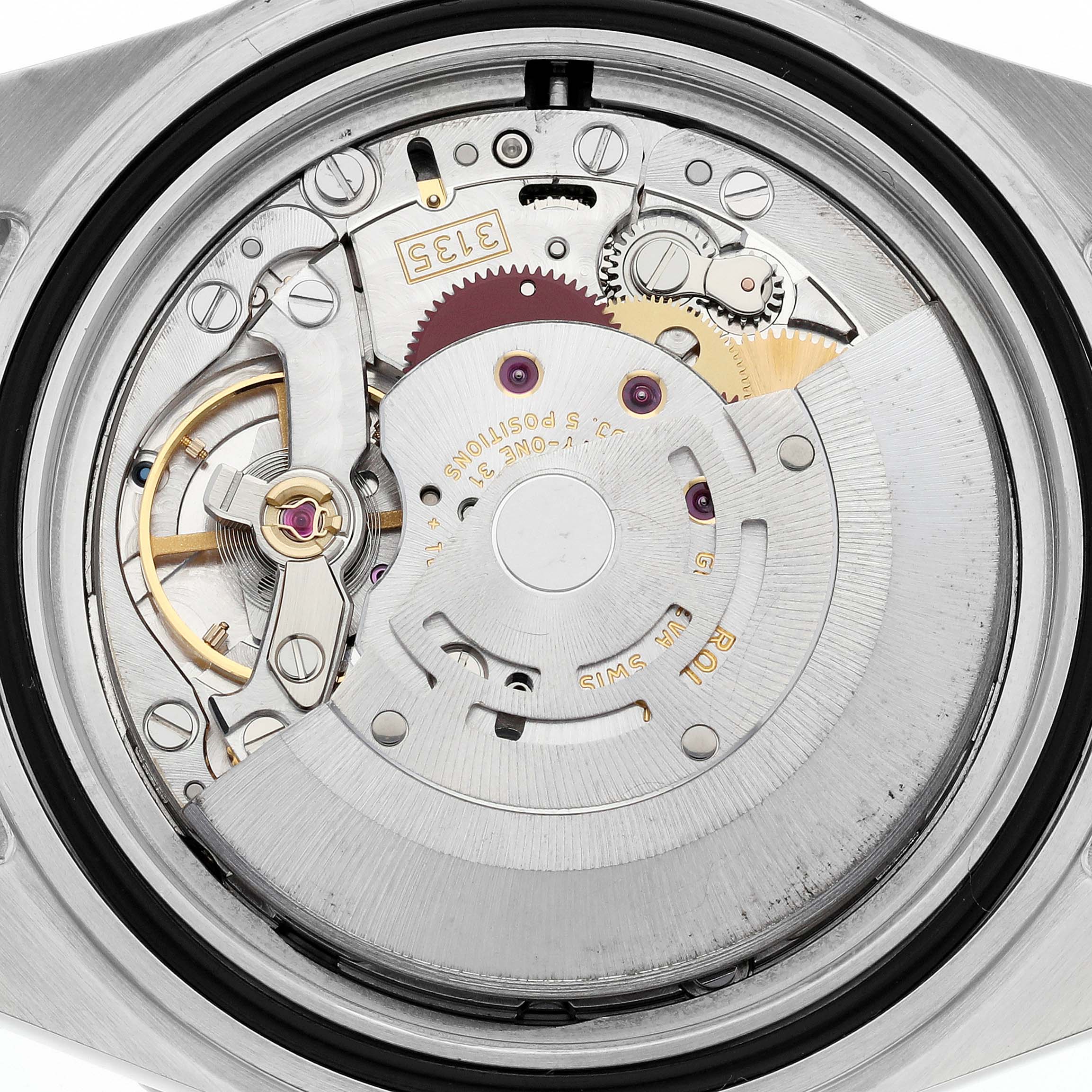 The image shows a close-up view of the Rolex Submariner 16610 Men
s Stainless Steel Black Dial 16610 Men
s Stainless Steel Black Dial
s open case back, revealing its intricate movement components.