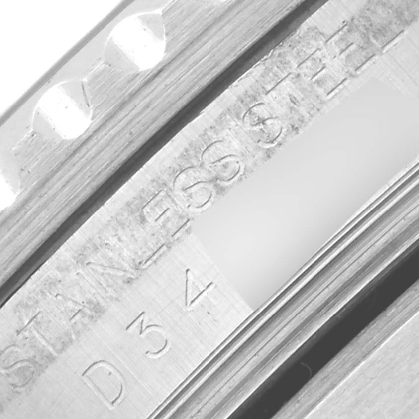 Close-up view of the side of a Rolex Submariner 16610 Men
s Stainless Steel Black Dial 16610 Men
s Stainless Steel Black Dial watch, showing the engraved "Stainless Steel" text and serial number.