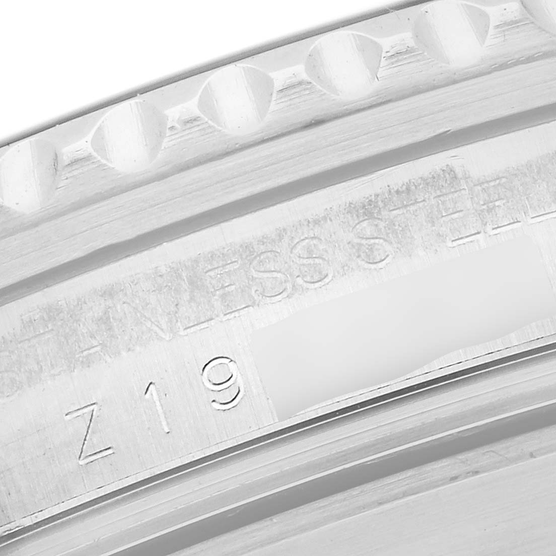 The image shows a close-up of the inner case and bezel area of a Rolex Submariner 16610 Men's Stainless Steel Black Dial 16610 Men's Stainless Steel Black Dial, highlighting the engraved text and serial number.
