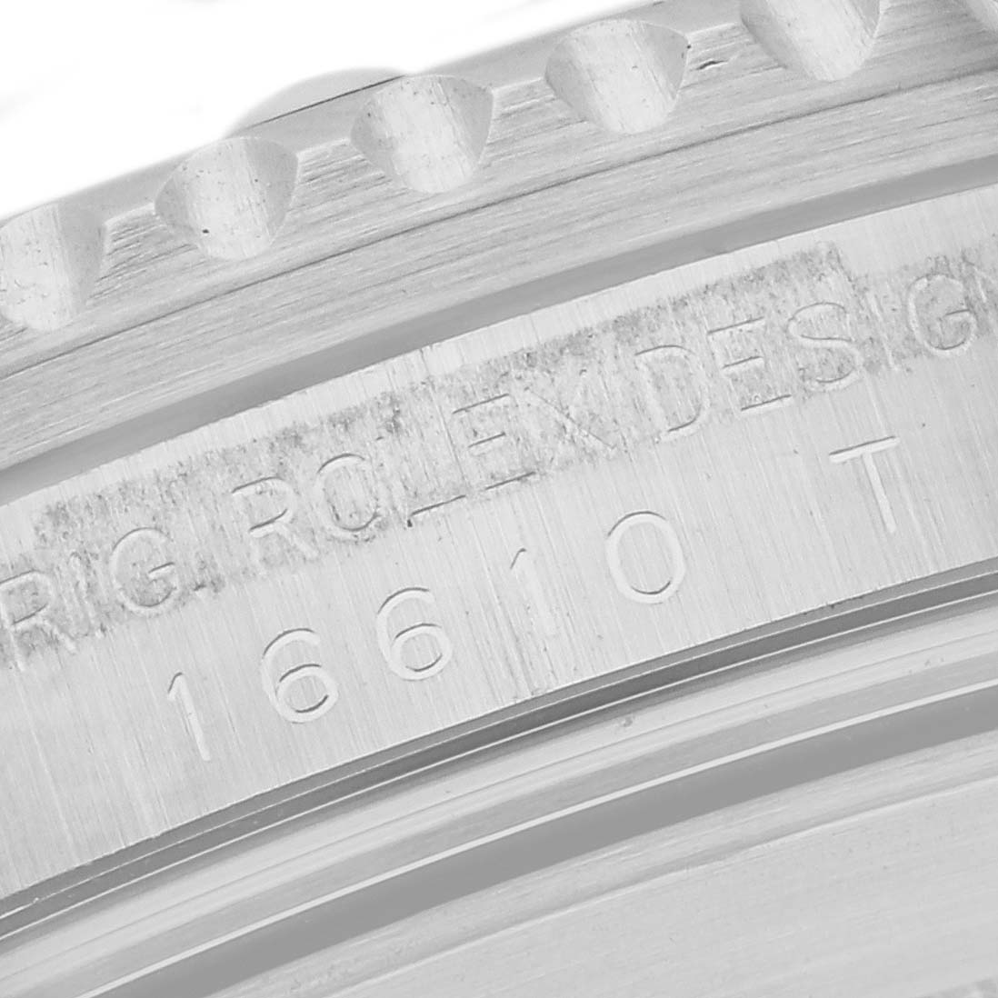The image shows a close-up of the engraved inner bezel and part of the outer bezel of a Rolex Submariner 16610 Men's Stainless Steel Black Dial 16610 Men's Stainless Steel Black Dial watch.