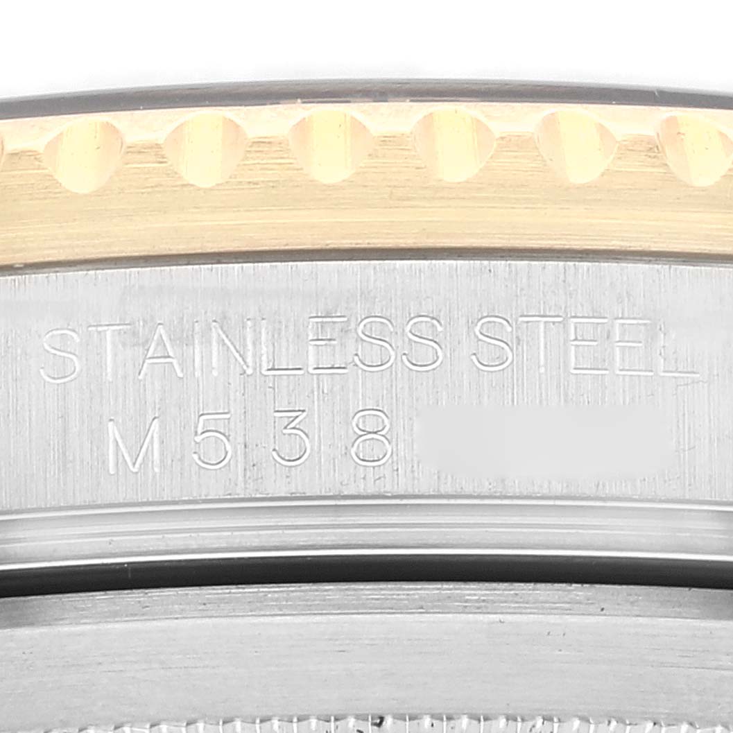 This image shows a close-up of the inner case back engraving and outer bezel of a Rolex Submariner 16613 Men's Steel and Gold (two tone) Black Dial 16613 Men's Steel and Gold (two tone) Black Dial watch.
