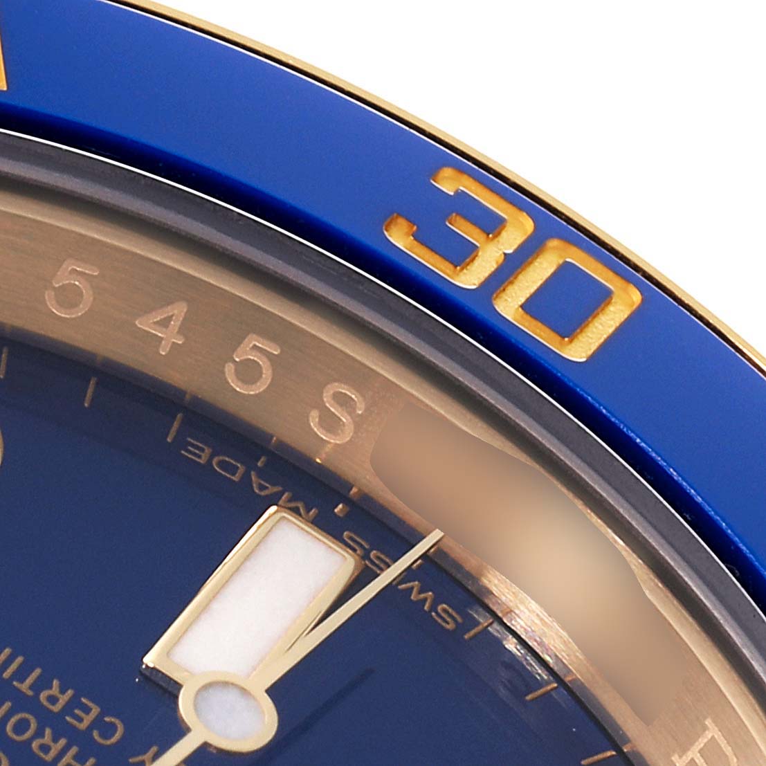 The image shows a close-up of the bezel and dial of a Rolex Submariner 116618 Men's Yellow Gold Blue Dial 116618 Men's Yellow Gold Blue Dial watch, highlighting the '30' marker and part of the minute hand.