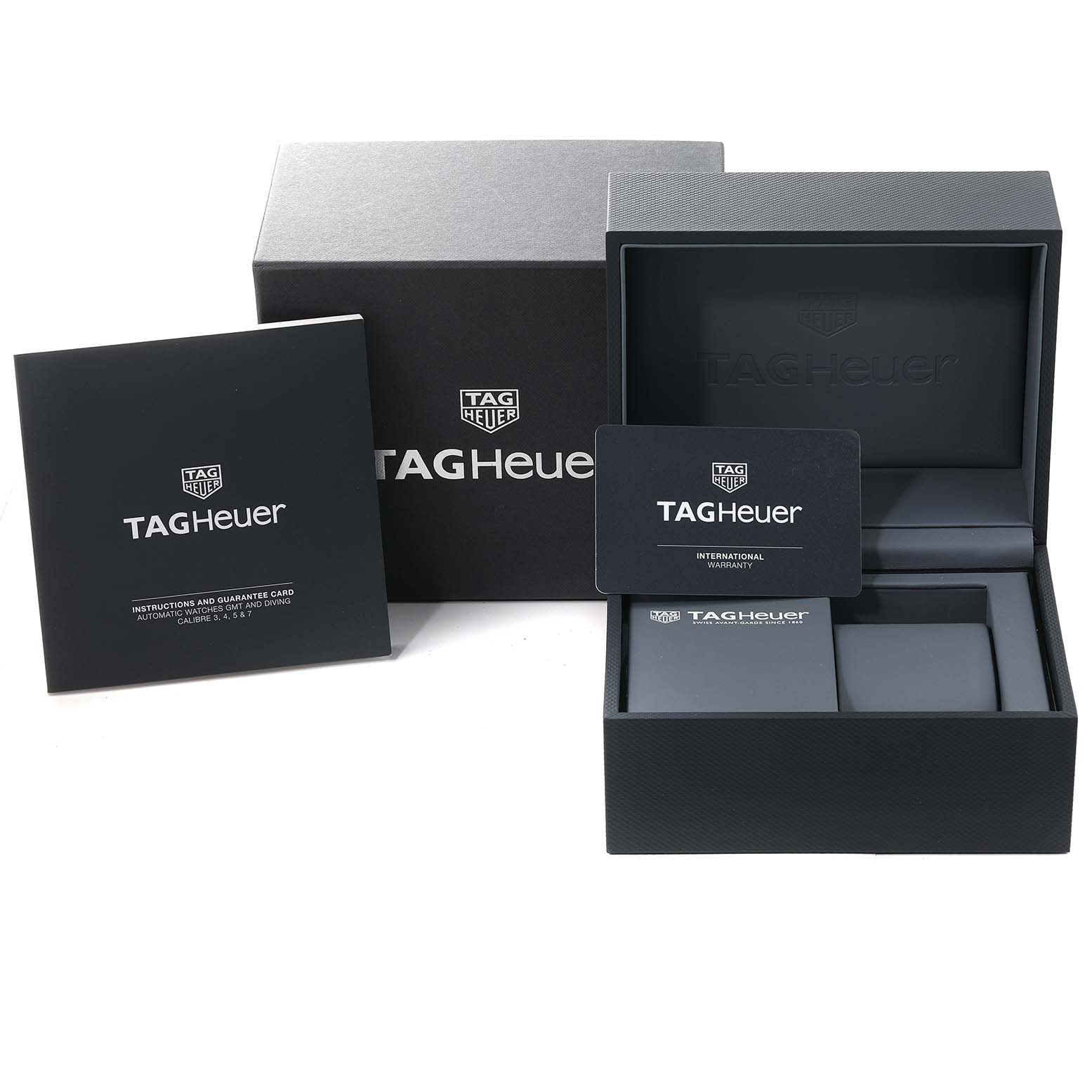 The image shows the packaging, warranty card, and instruction booklet for a Tag Heuer Carrera CAR201T Men's Stainless Steel Blue Dial CAR201T Men's Stainless Steel Blue Dial watch.