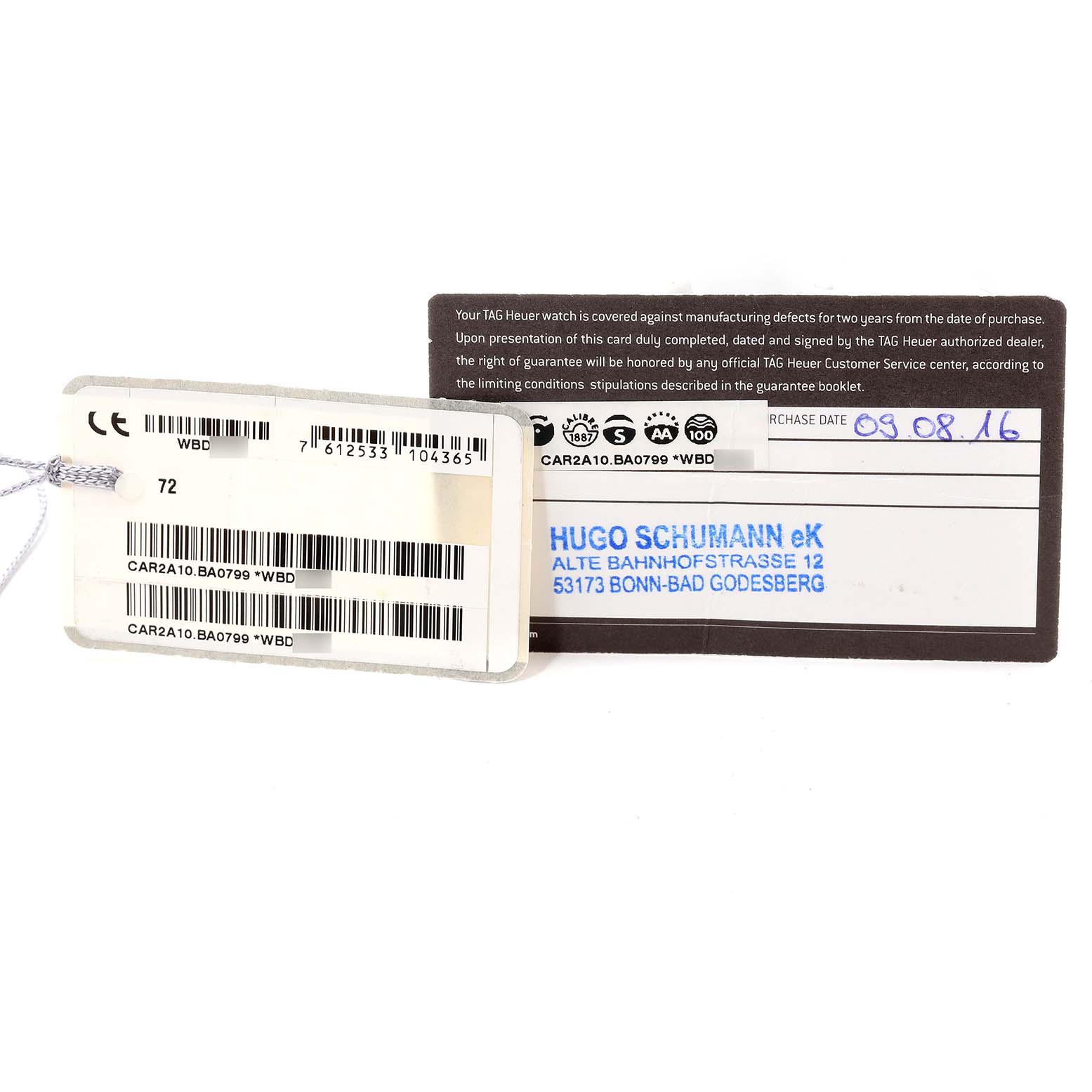 The image shows the tags and warranty card of a Tag Heuer Carrera CAR2A10-2 Men's Stainless Steel Black Dial CAR2A10-2 Men's Stainless Steel Black Dial model watch, displaying barcodes and purchase information.