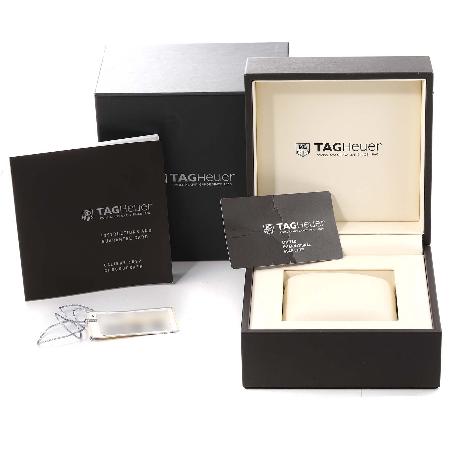 The image shows the packaging and documentation for the Tag Heuer Carrera CAR2A10-2 Men's Stainless Steel Black Dial CAR2A10-2 Men's Stainless Steel Black Dial watch, including the box, instruction manual, and guarantee card.
