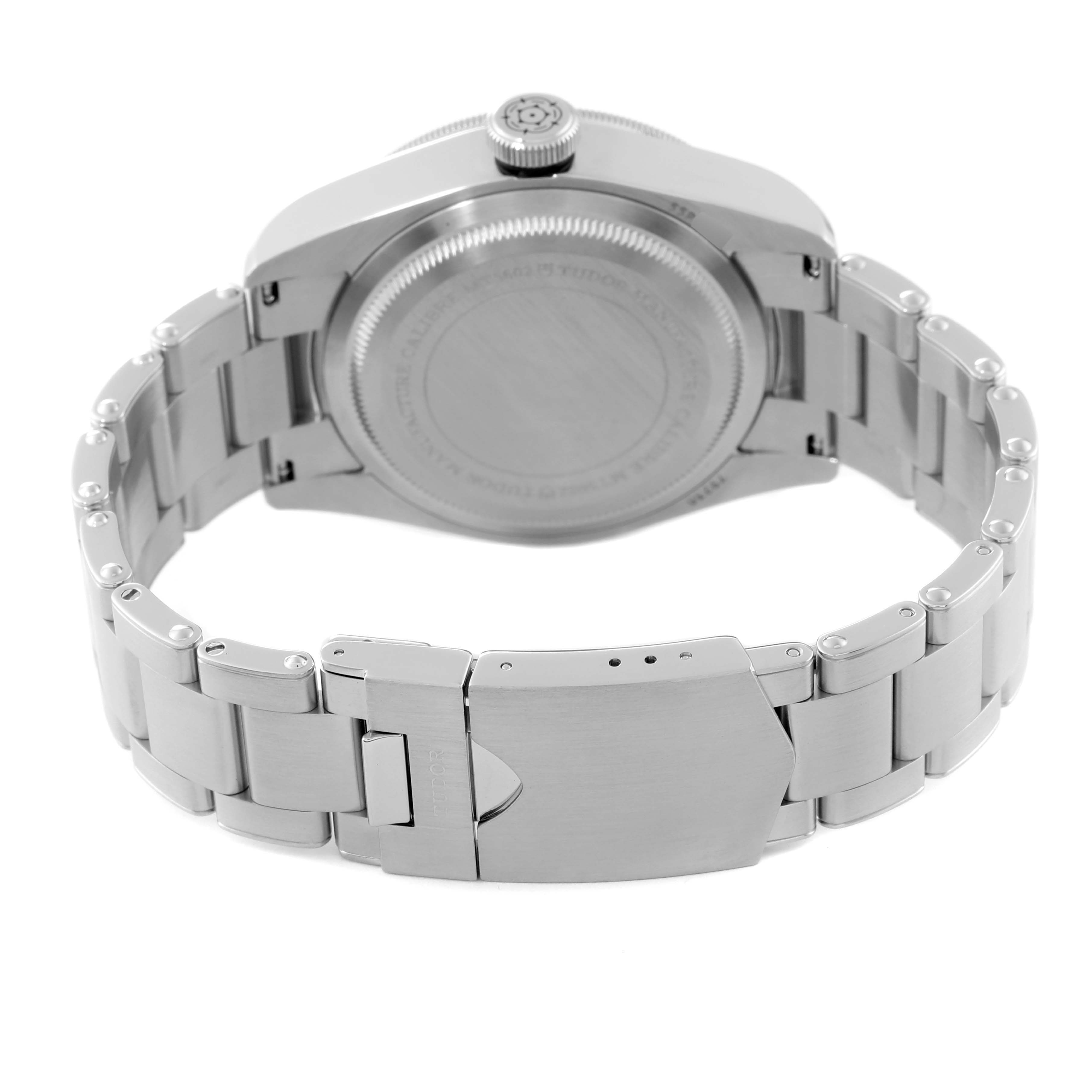 The image shows the back view of a Tudor Heritage Black Bay 79230N Men
s Stainless Steel Black Dial 79230N Men
s Stainless Steel Black Dial watch, focusing on the case back and bracelet clasp.