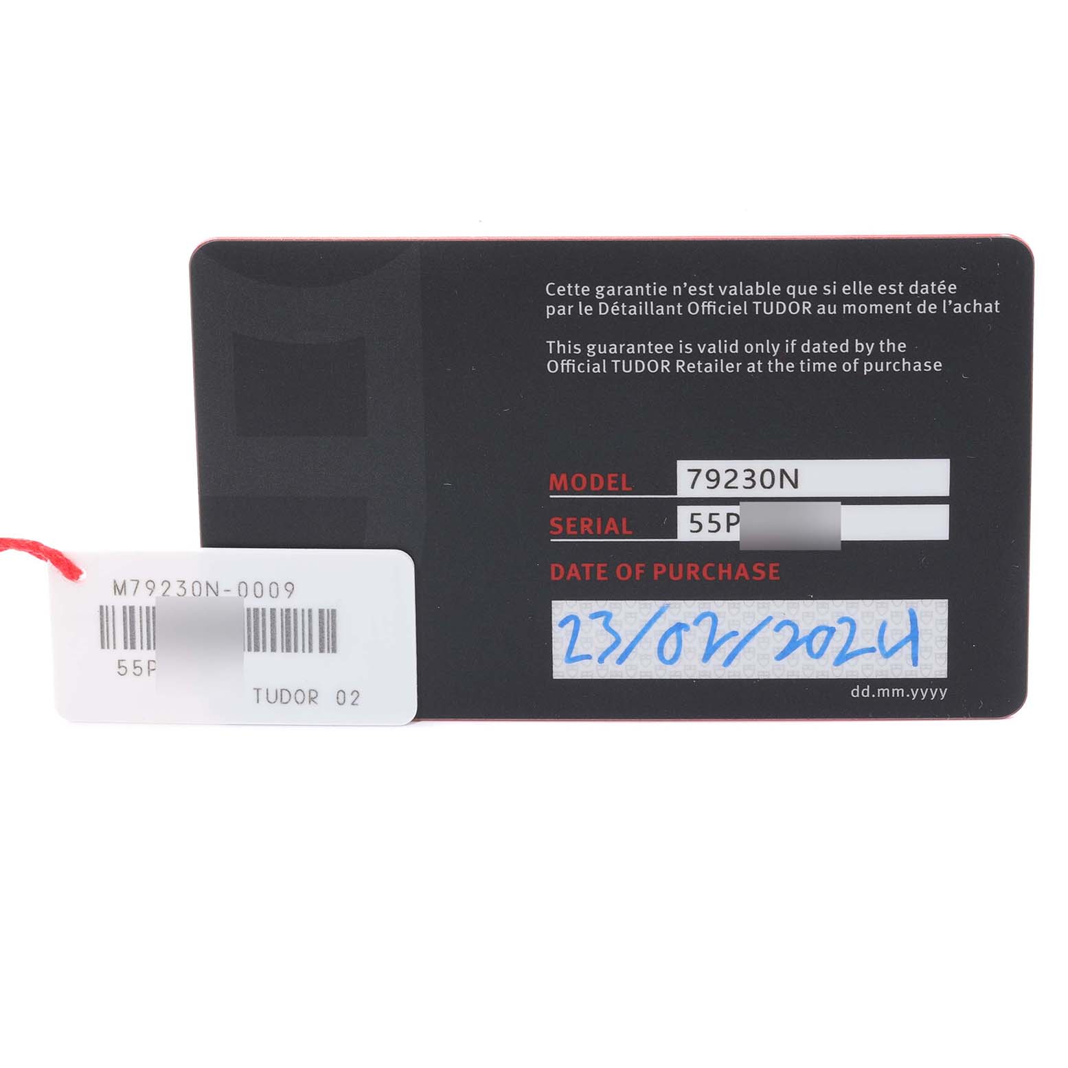 This image shows the warranty card and tag for a Tudor Heritage Black Bay 79230N Men
s Stainless Steel Black Dial 79230N Men
s Stainless Steel Black Dial model 79230N watch.