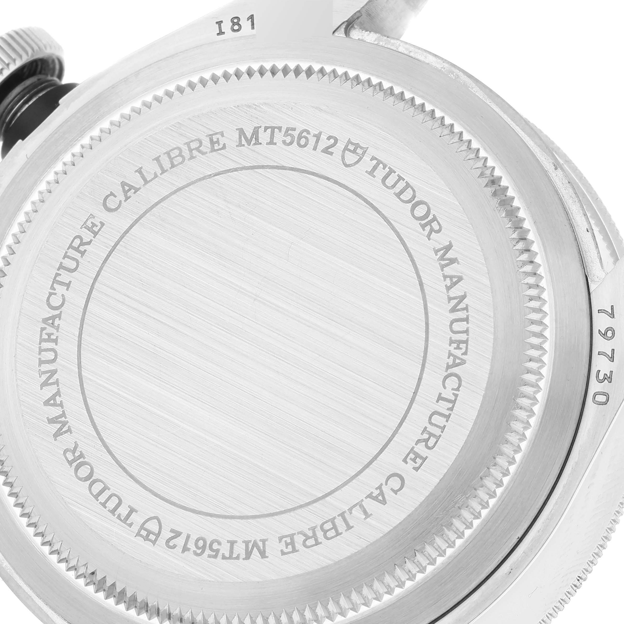 The image shows the case back of a Tudor Heritage Black Bay 79730 Men
s Stainless Steel Black Dial 79730 Men
s Stainless Steel Black Dial watch, focusing on the inscription and serial number.