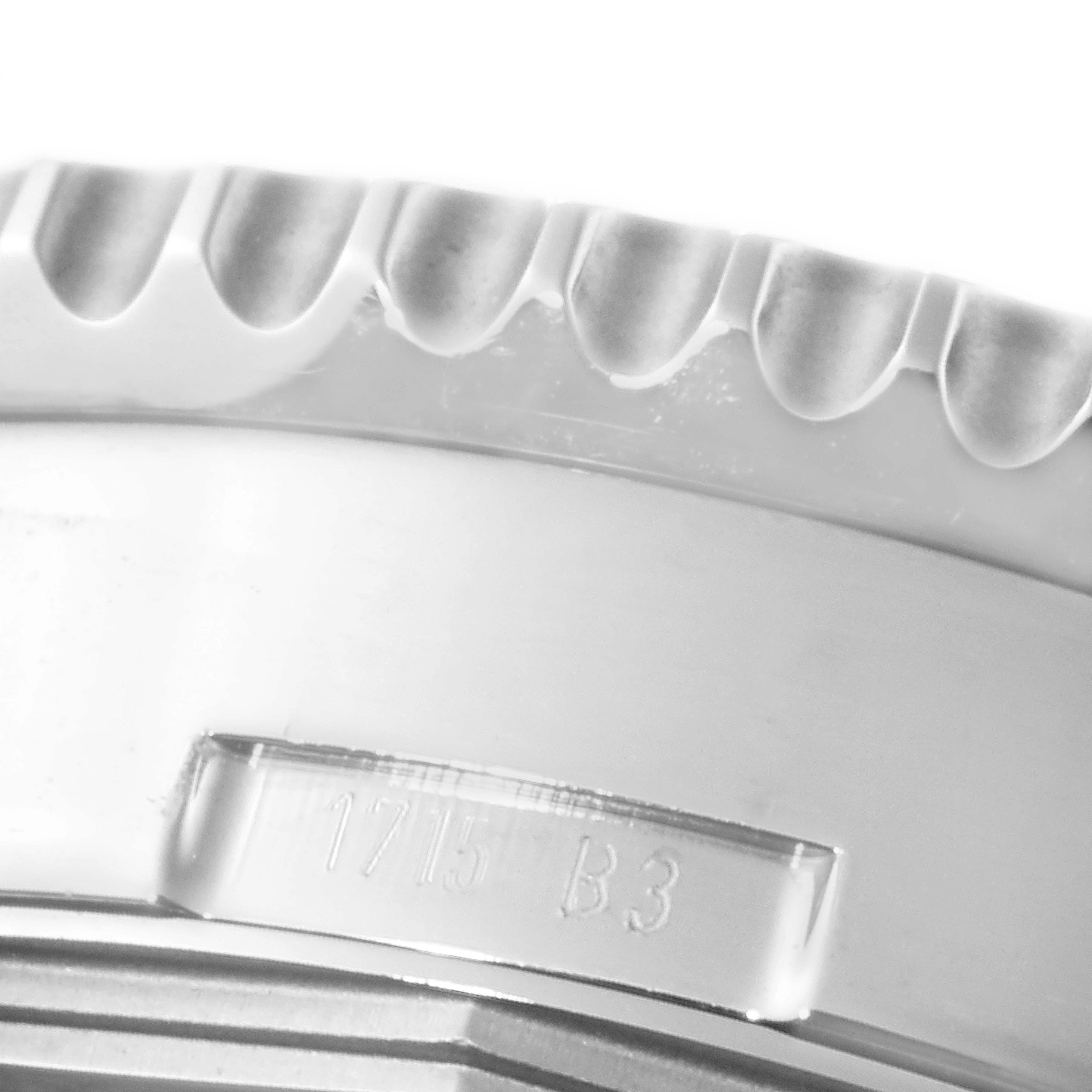 This image shows a close-up of the bezel and side casing of the Breitling Navitimer AB0127-211-B1A1 Men's Stainless Steel Black Dial AB0127-211-B1A1 Men's Stainless Steel Black Dial watch, including the serrated edge and model engravings.