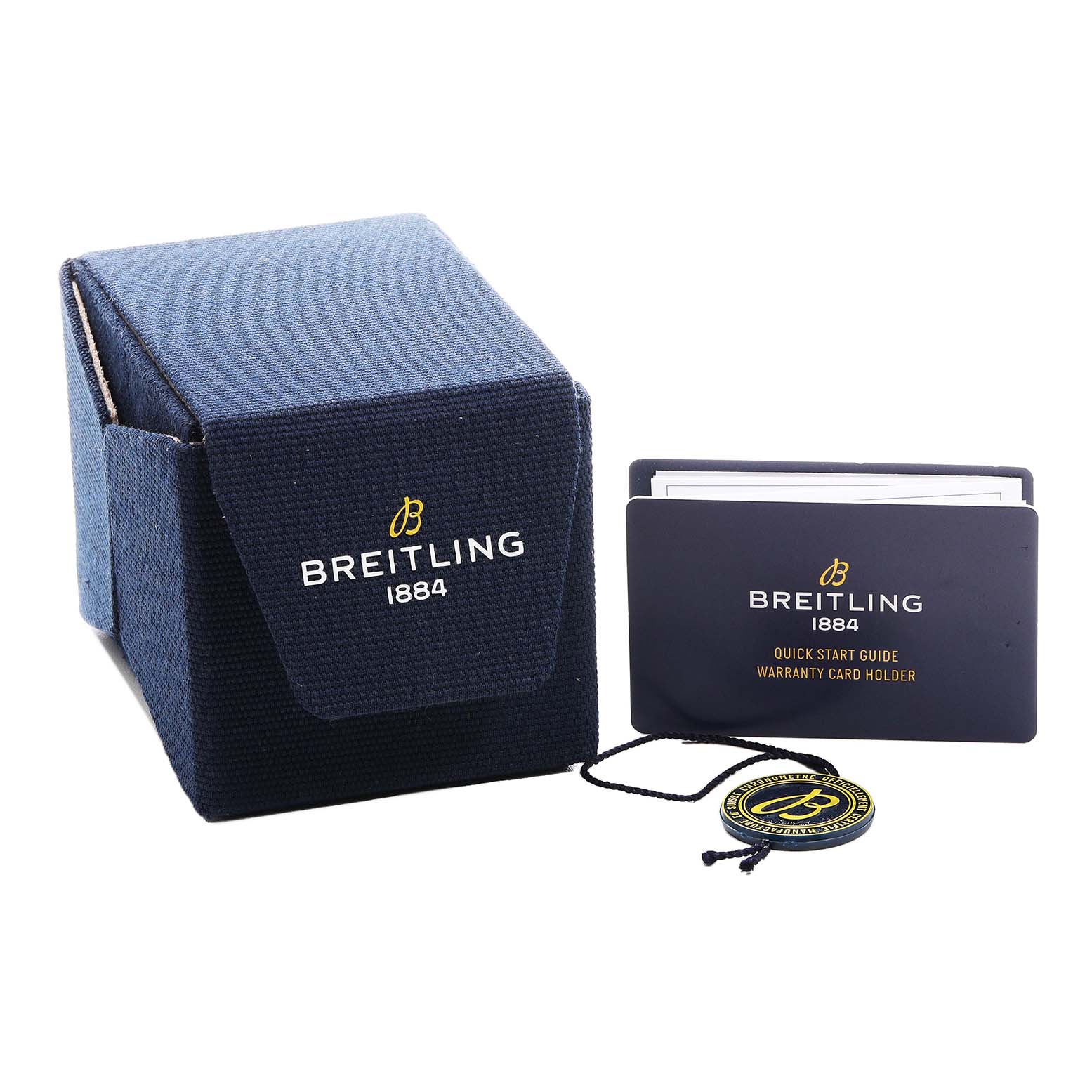 The image shows a Breitling Navitimer A32310 Men's Stainless Steel Silver Dial box, a warranty card holder, booklet, and a branded medallion tag.