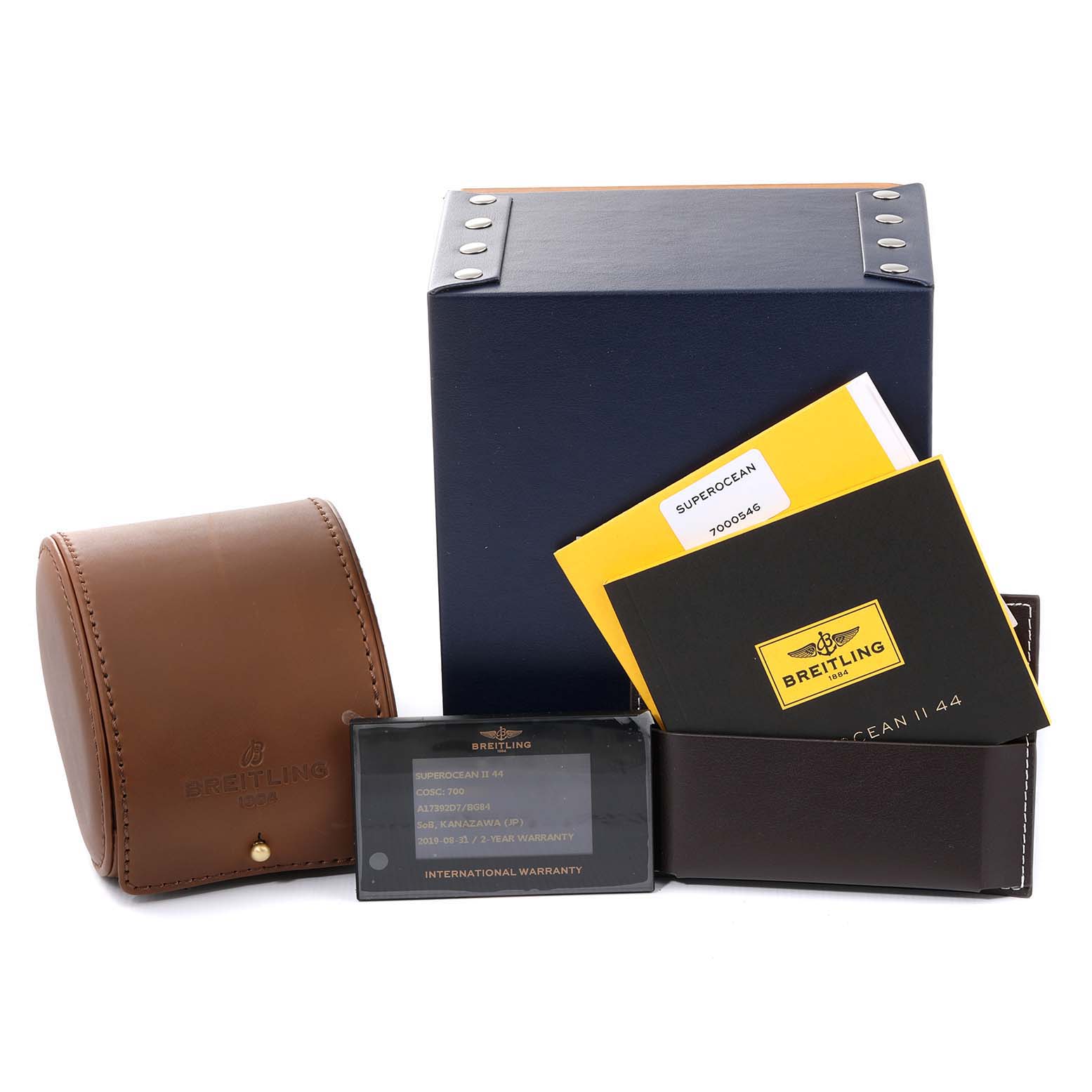 The image shows accessories for the Breitling Superocean A17392D8/C910 Men's Stainless Steel Black Dial A17392D8/C910 Men's Stainless Steel Black Dial, including a leather case, warranty card, manuals, and a branded box, from a frontal angle.