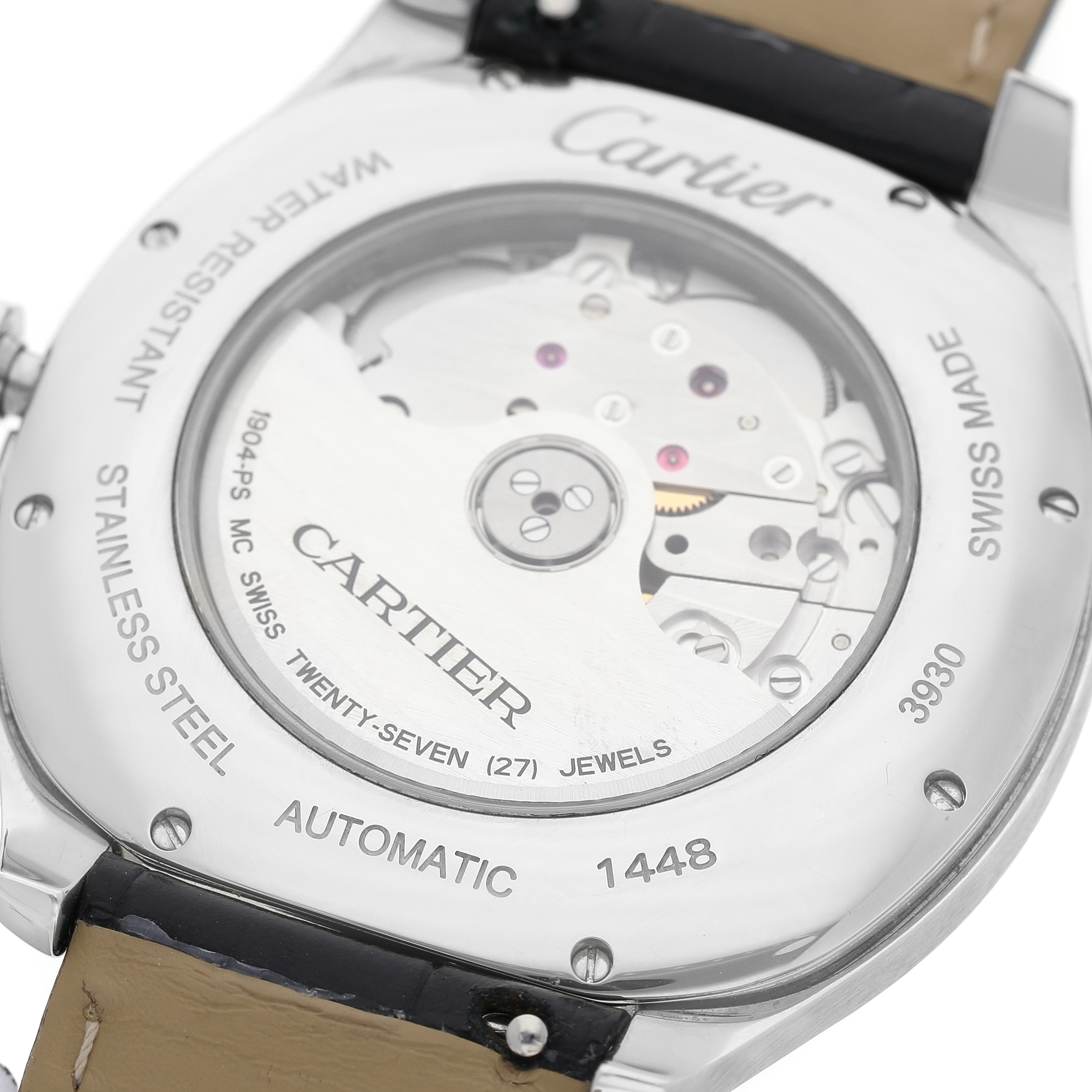 The image shows the back of the Drive de Cartier watch, revealing its automatic movement and stainless steel casing.