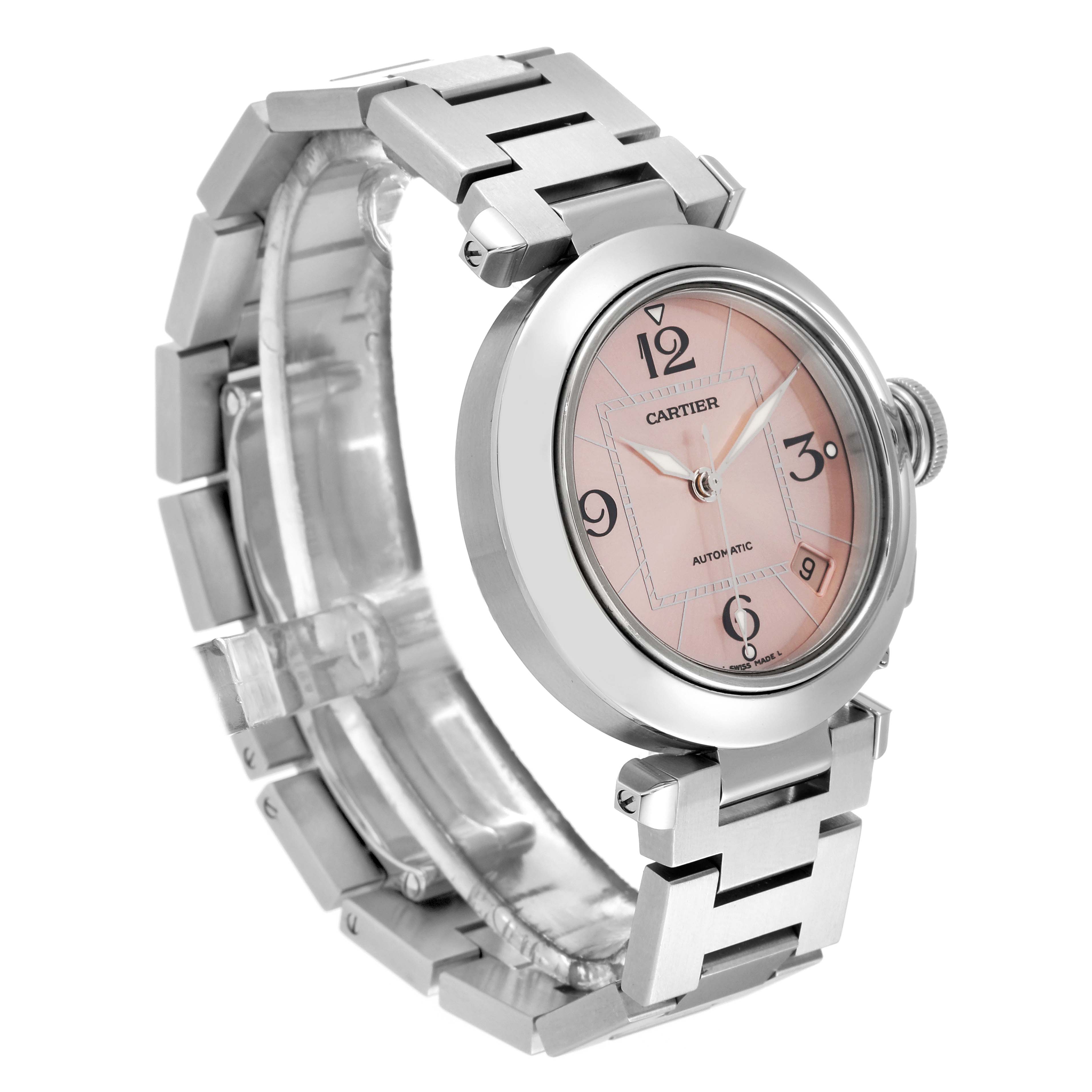 The Cartier Pasha W31075M7 Women's Stainless Steel Pink Dial W31075M7 Women's Stainless Steel Pink Dial watch is shown at an oblique angle, highlighting its round face, bracelet, crown, and metal band.