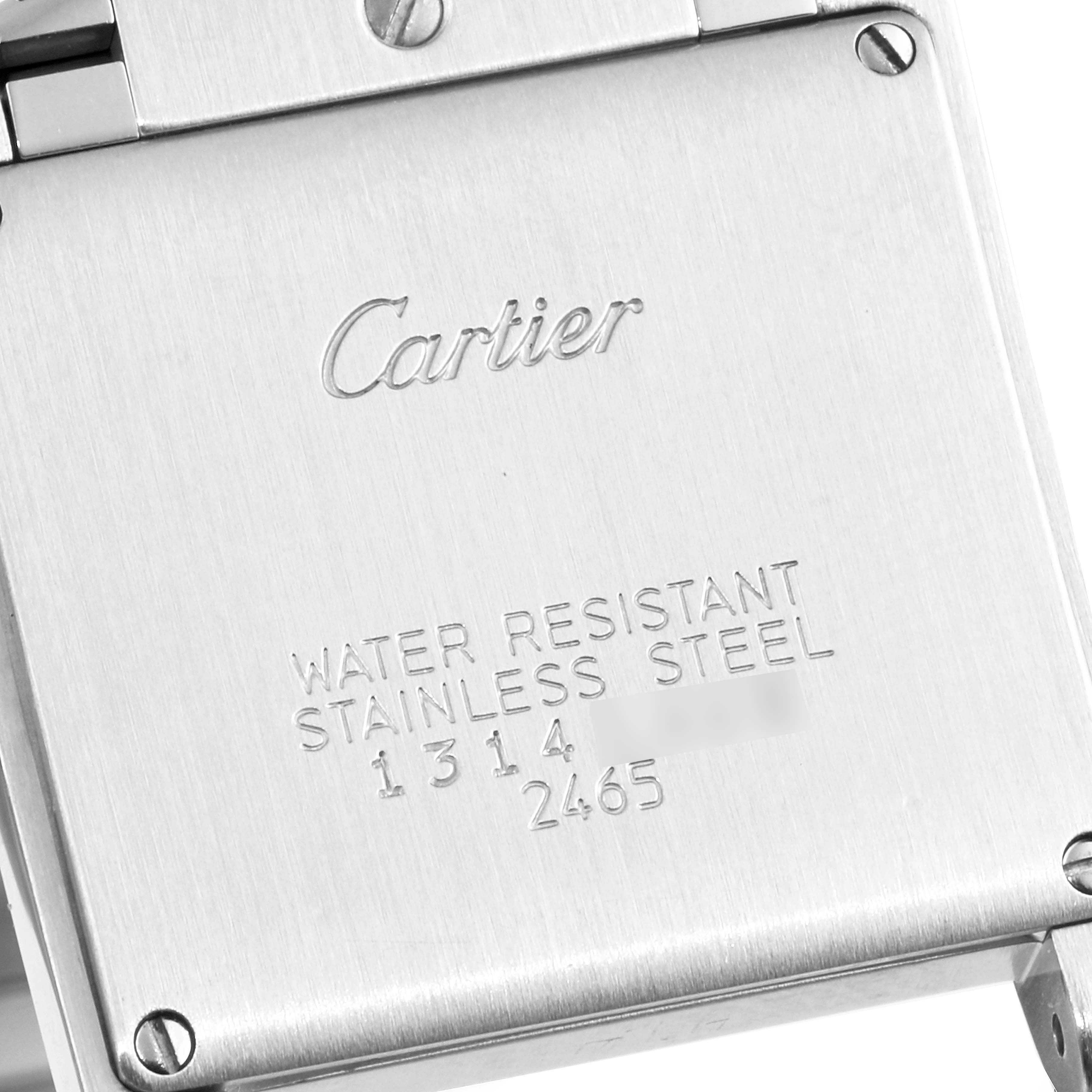 The image shows the stainless steel case back of a Cartier Tank Française watch.