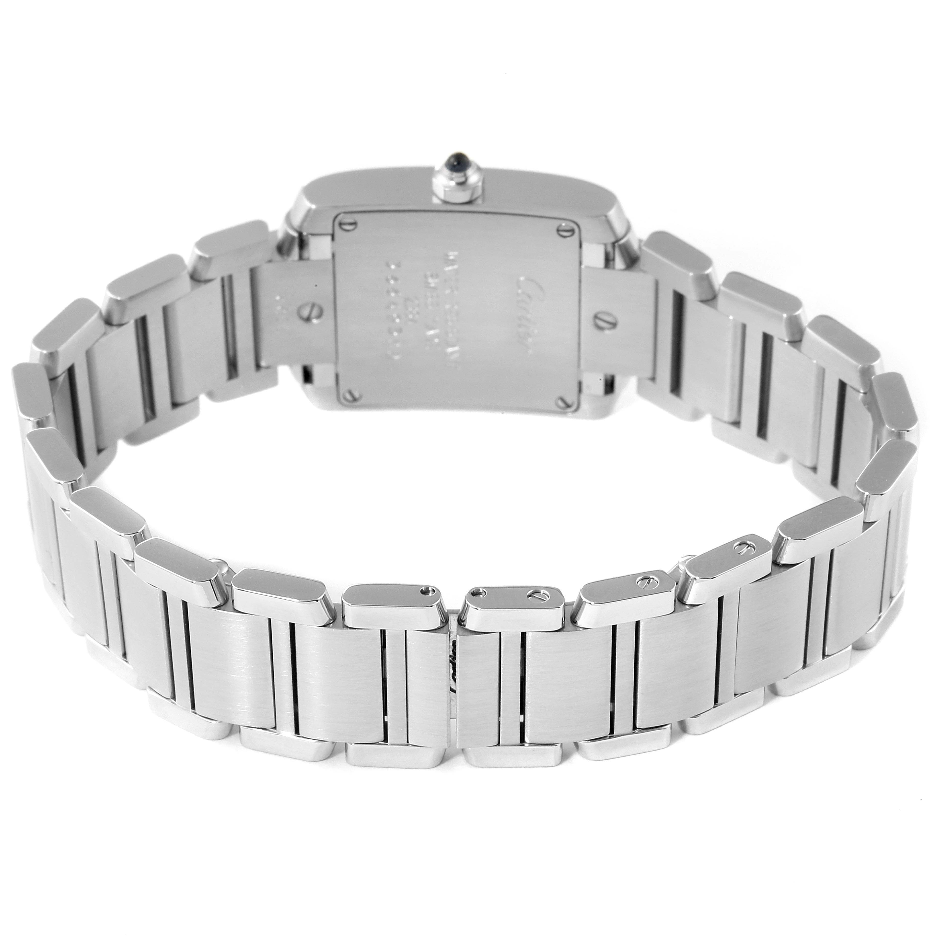 The image shows the back view of a Tank Francaise watch by Cartier, highlighting its metal bracelet and case back.