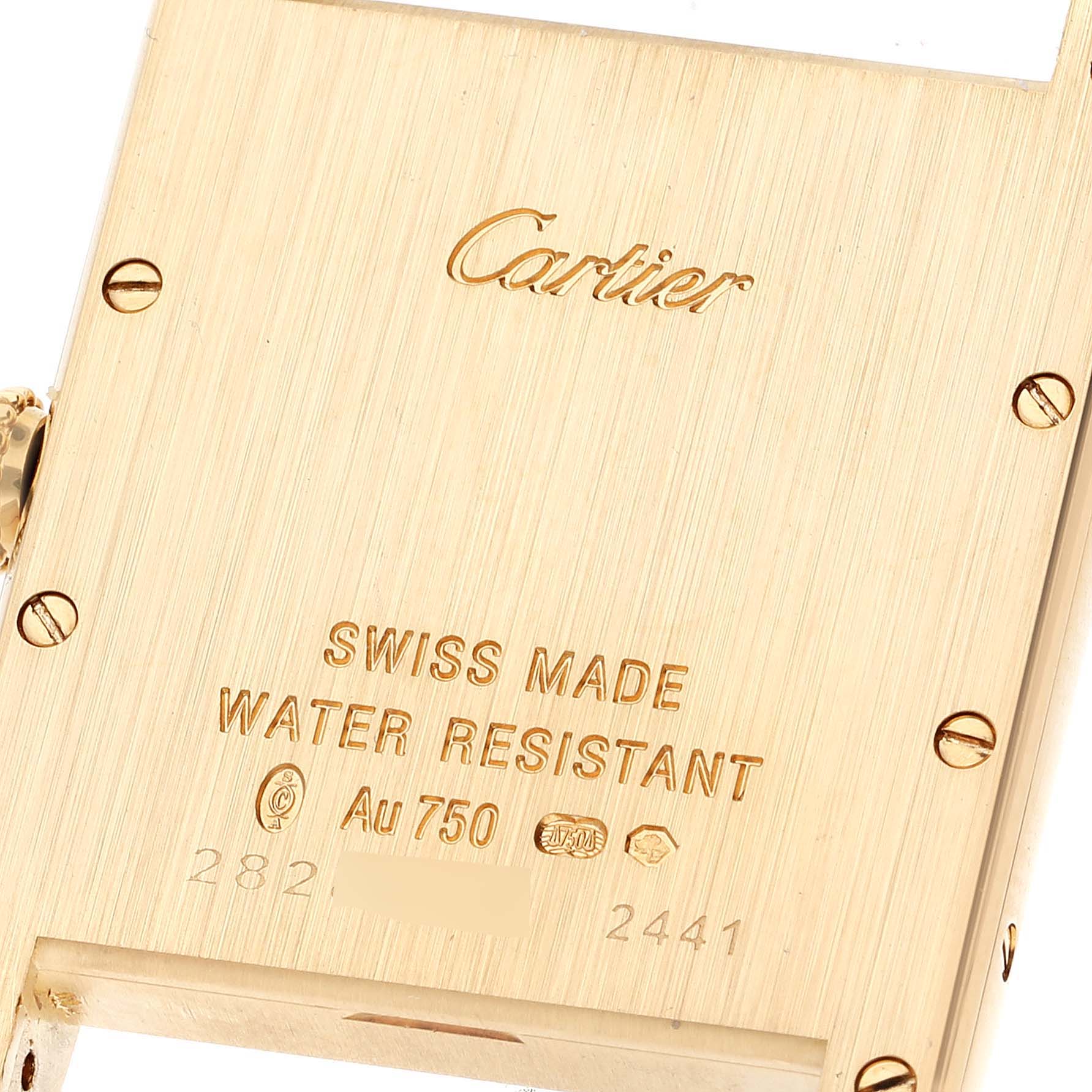 This image shows the backside of a Tank Louis Cartier watch, highlighting the engravings and screws.