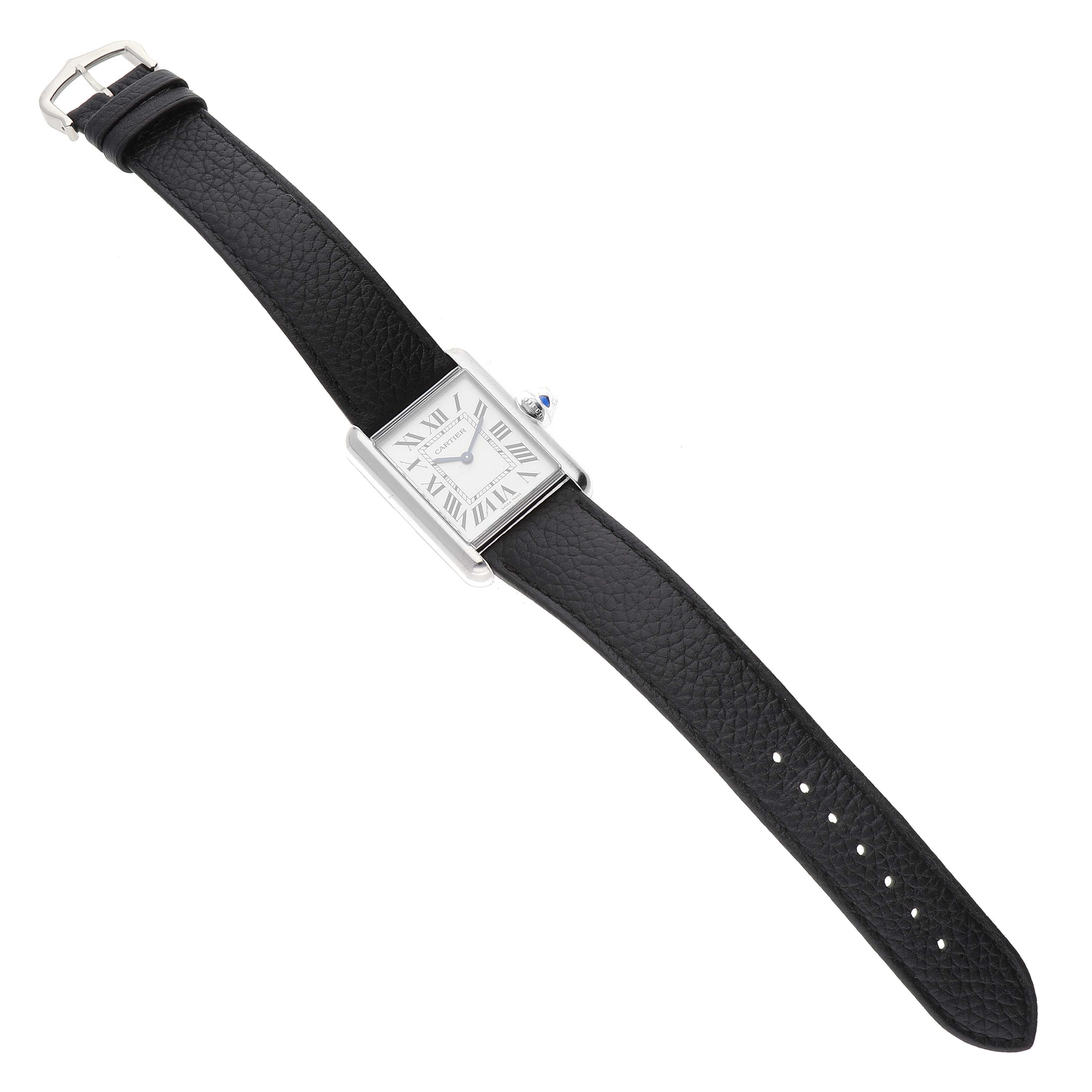 The image shows a top view of a Cartier Tank Must WSTA0041 Women's Stainless Steel Silver Dial WSTA0041 Women's Stainless Steel Silver Dial watch with a black leather strap and a rectangular dial.