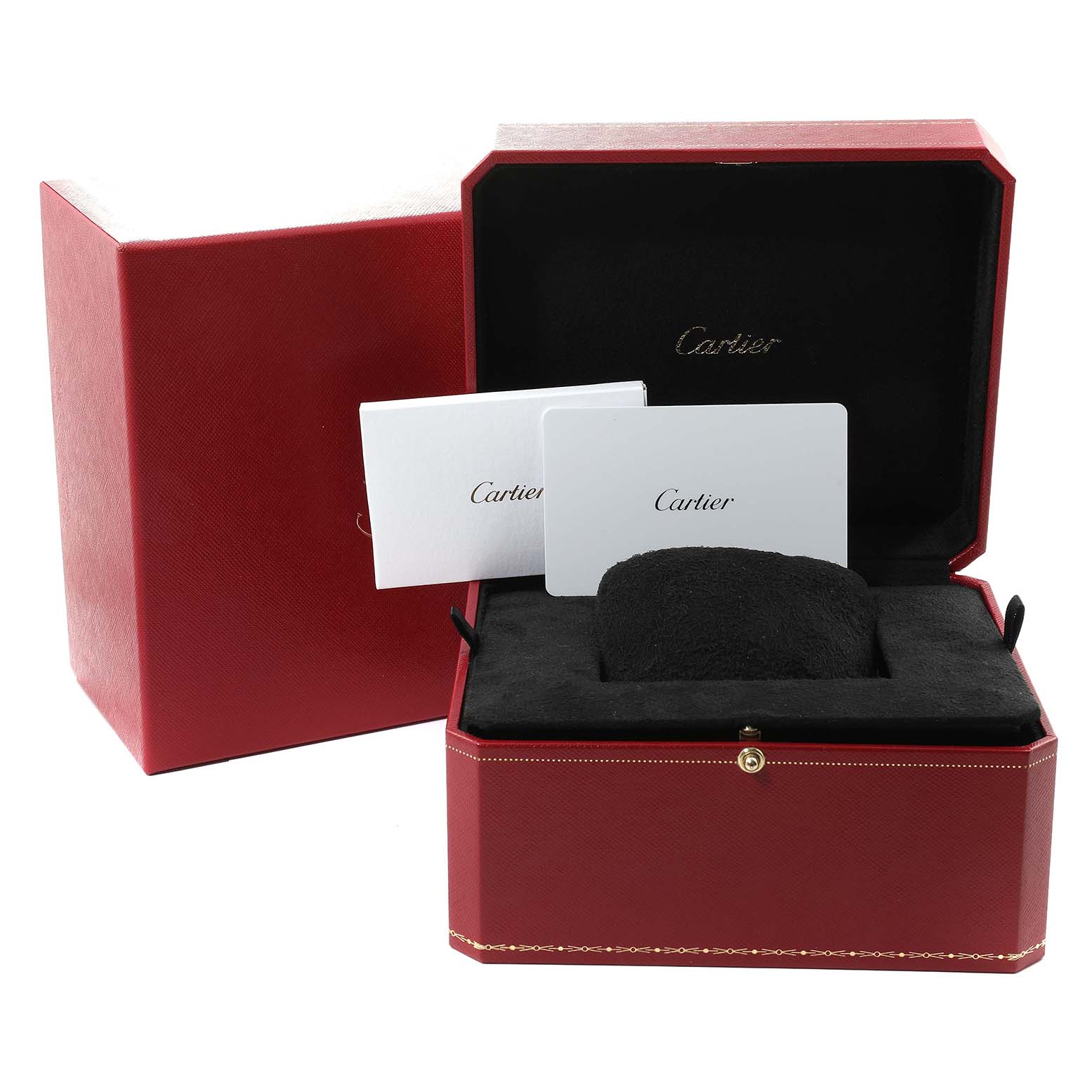The image shows the packaging and accessories of a Tank Must by Cartier, including the open box, cushion, and documentation cards.