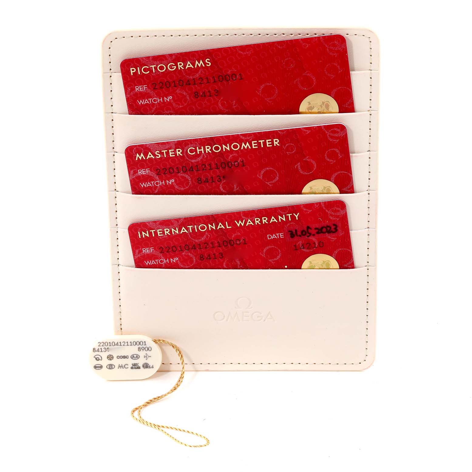 The image shows the warranty card holder with three cards and a tag, all belonging to the Omega Aqua Terra 220.10.41.21.10.001 Men's Stainless Steel Green Dial 220.10.41.21.10.001 Men's Stainless Steel Green Dial model.