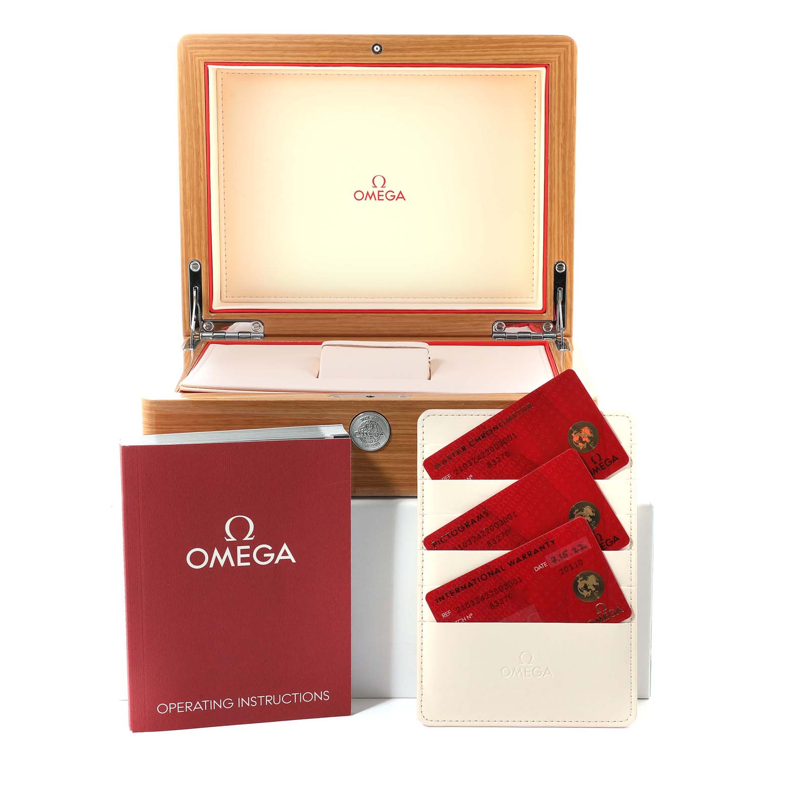 The image shows accessories for an Omega Seamaster 210.32.42.20.03.001 Men's Stainless Steel Blue Dial 210.32.42.20.03.001 Men's Stainless Steel Blue Dial watch, including a wooden box, operating instructions, and warranty cards.