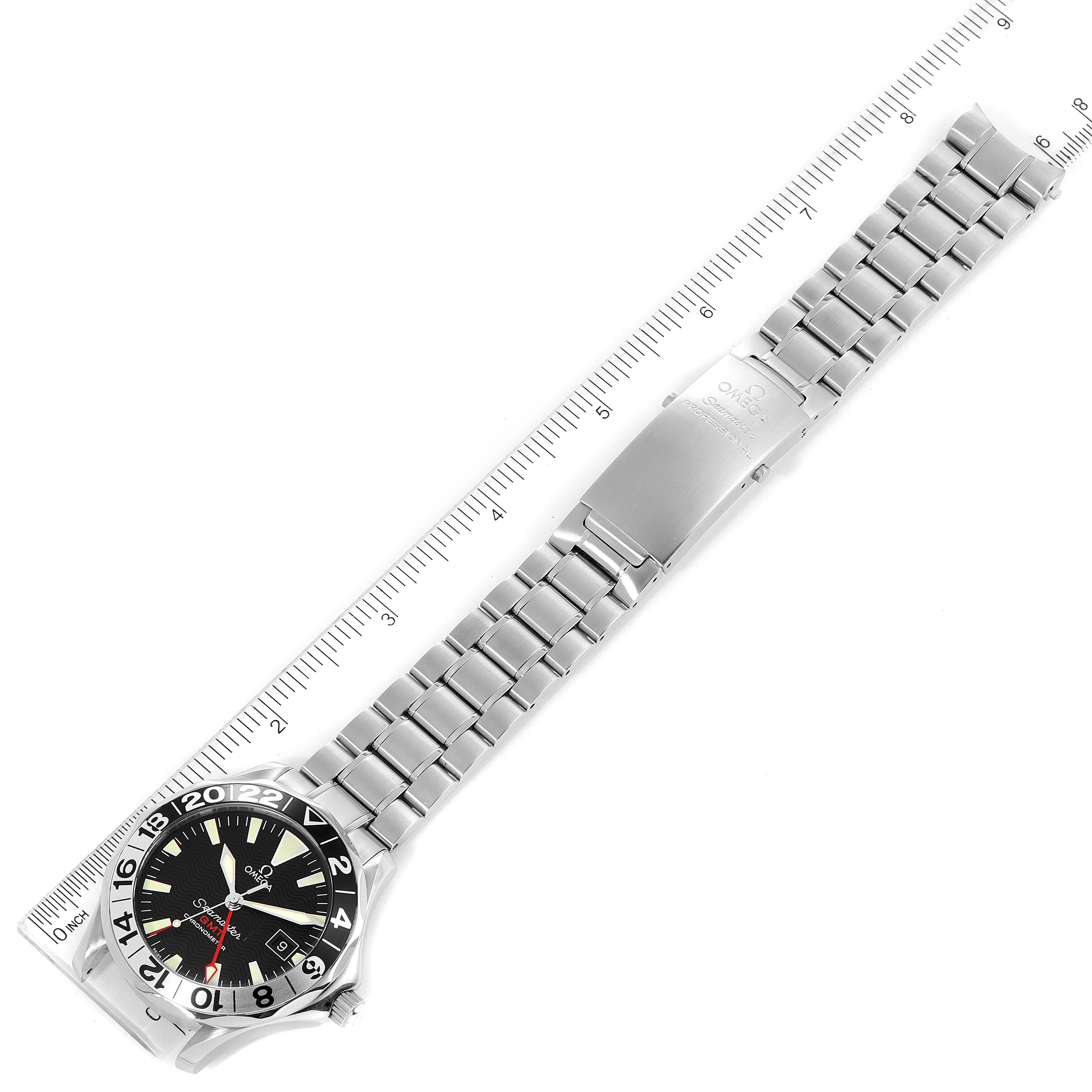 The image shows an Omega Seamaster 2234.50.00 Men's Stainless Steel Black Dial 2234.50.00 Men's Stainless Steel Black Dial watch from a top-down angle, displaying the entire bracelet and watch face along with a ruler for size reference.