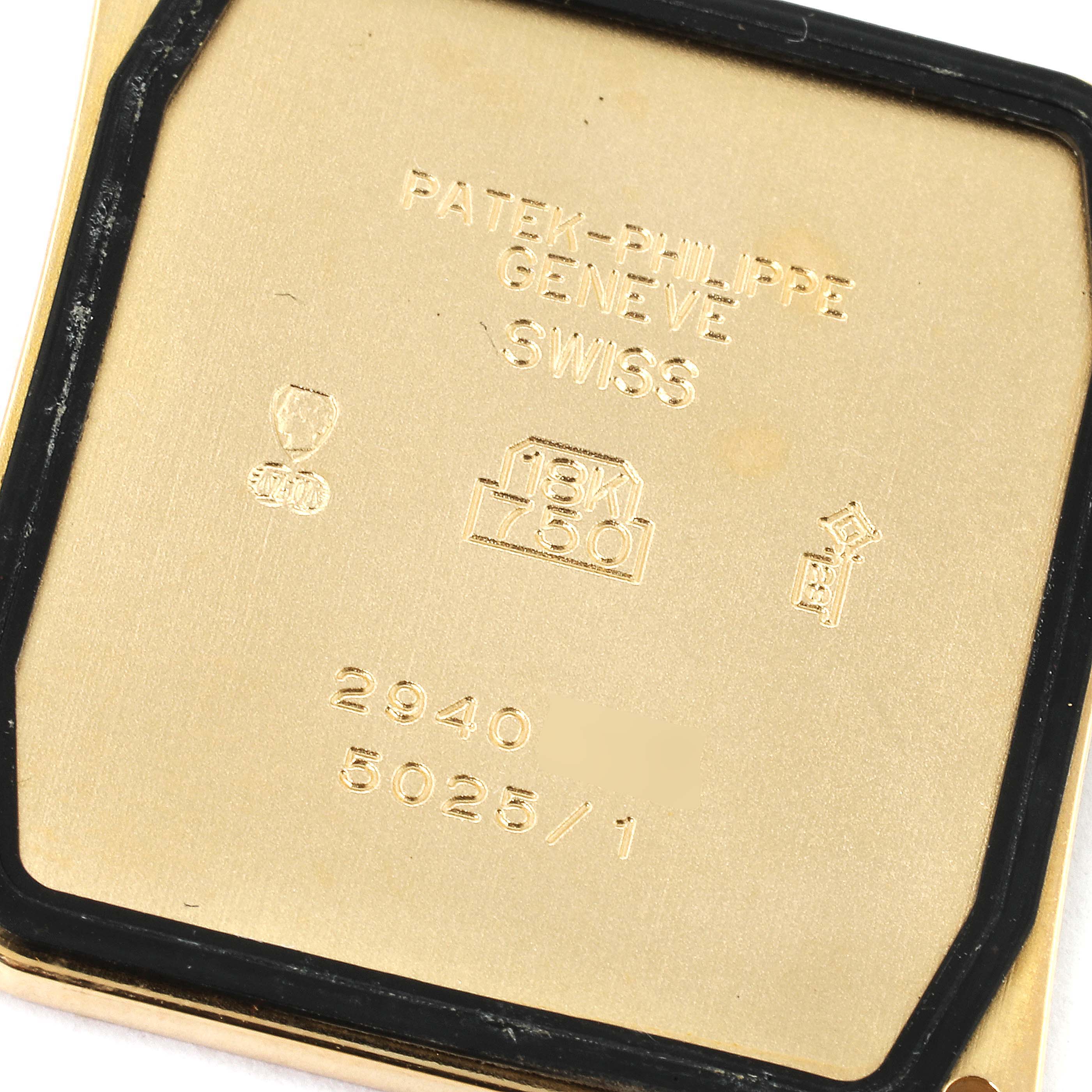 This is the back case of a Patek Philippe Gondolo 5025/1J Men's Yellow Gold White Dial 5025/1J Men's Yellow Gold White Dial watch, displaying engravings including the model number and gold content.