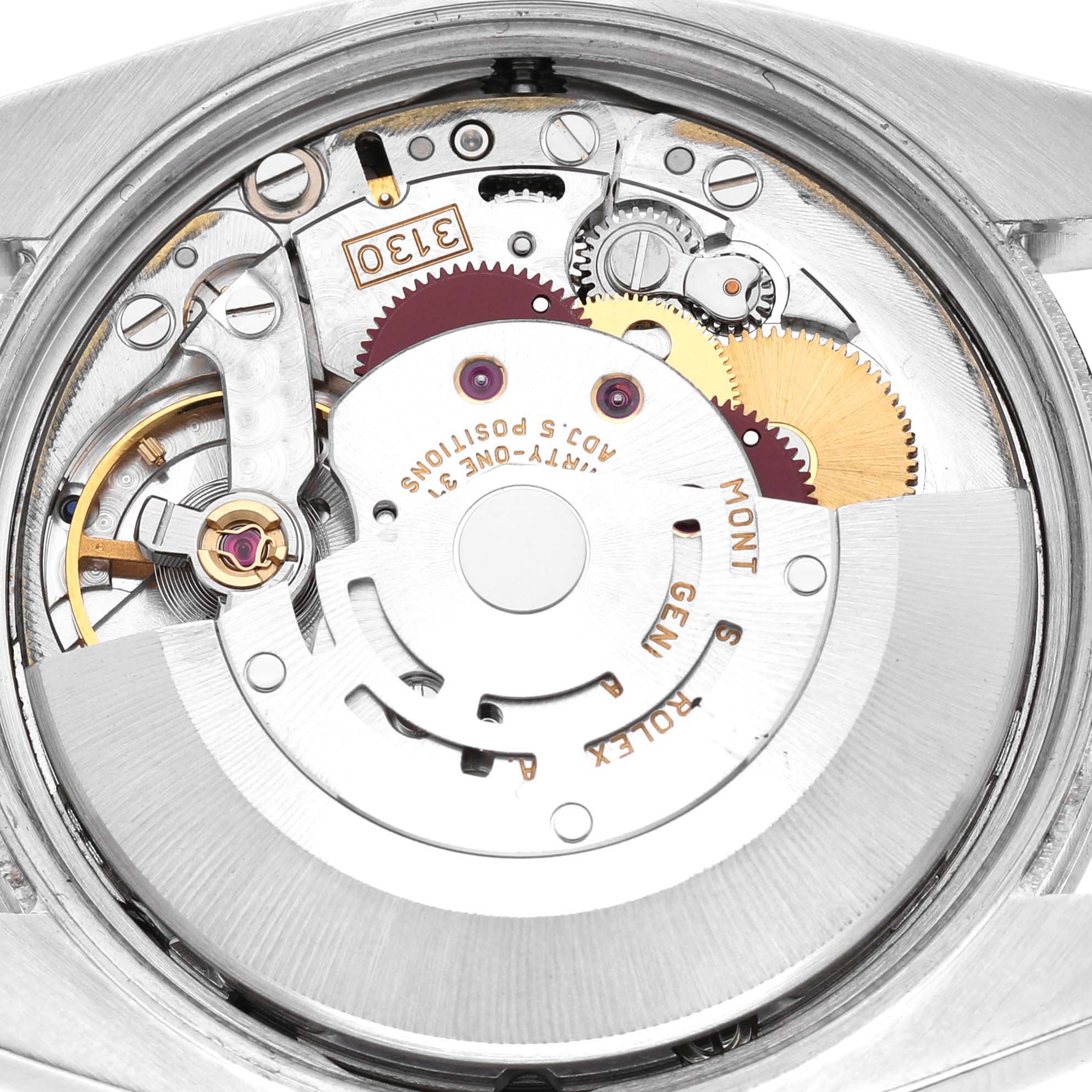 The image shows the internal movement of a Rolex Air-King 114200 Men's Stainless Steel Blue Dial watch from a rear angle, highlighting gears and components.