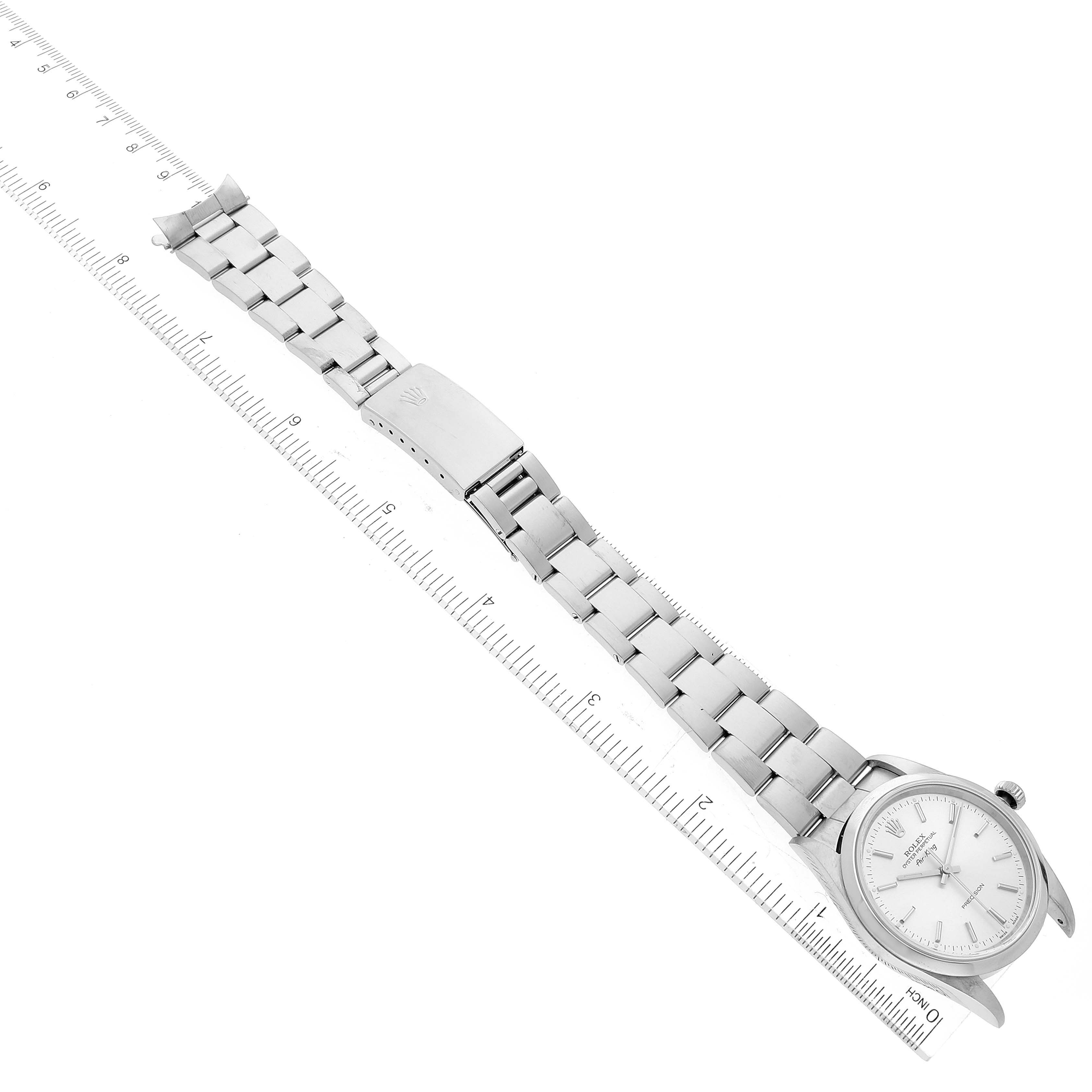 This image shows an overhead view of the Rolex Air-King 14000 Men's Stainless Steel Silver Dial 14000 Men's Stainless Steel Silver Dial watch including the bracelet, clasp, and dial positioned next to a ruler.