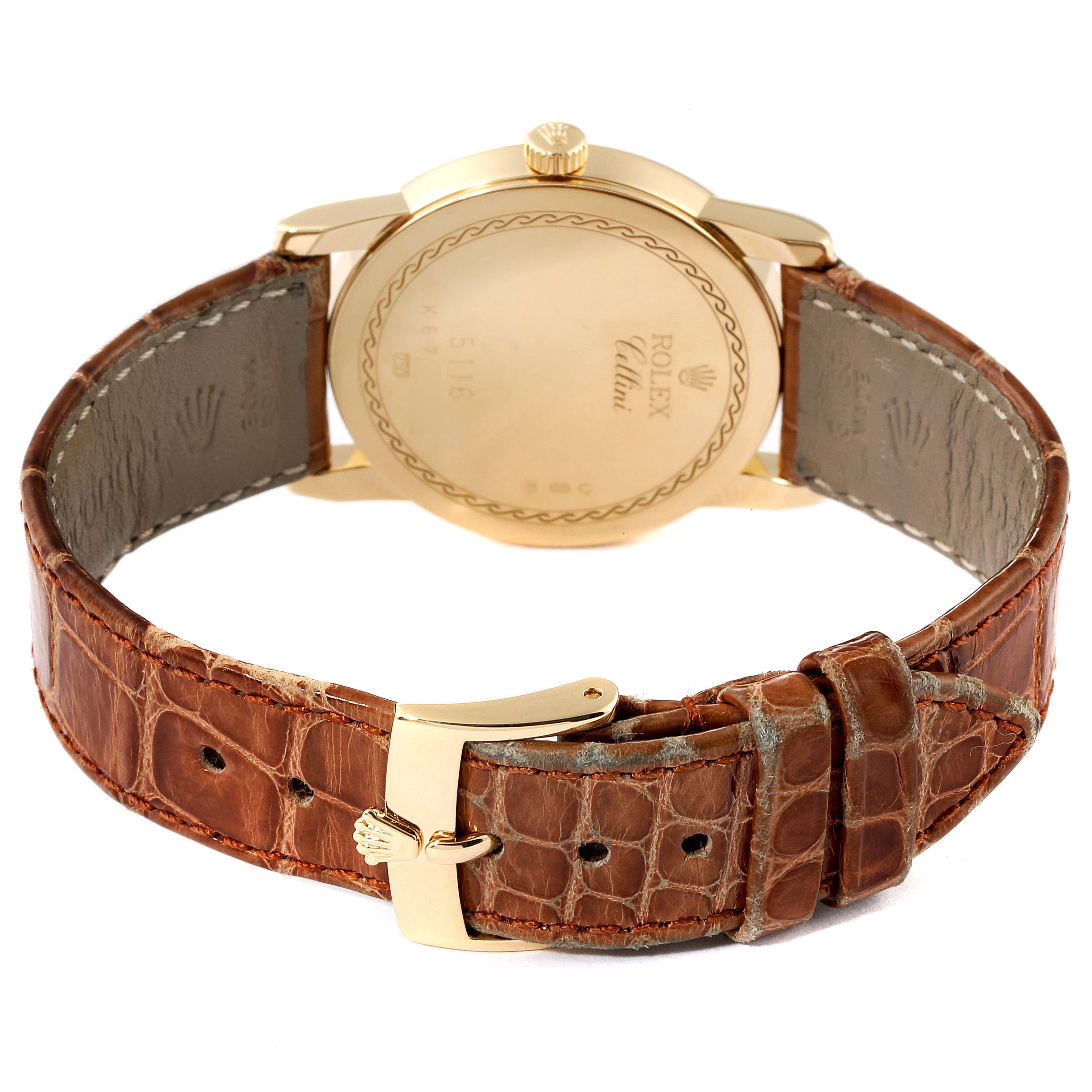 This image shows the back view of a Rolex Cellini 5116 Men's Yellow Gold Champagne Dial 5116 Men's Yellow Gold Champagne Dial model, highlighting its golden case and brown leather strap with a clasp.